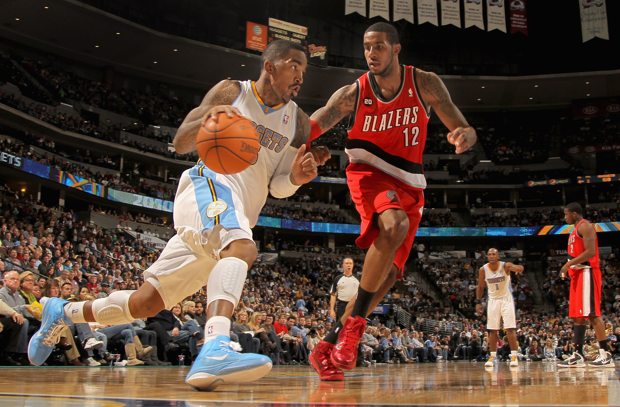 DENVER - DECEMBER 28:  J.R. Smith #5 of the Denver Nuggets drives around LaMarcus Aldridge #12 of the Portland Trail Blazers at Pepsi Center on December 28, 2010 in Denver, Colorado. The Nuggets defeated the Blazers 95-77. NOTE TO USER: User expressly ack