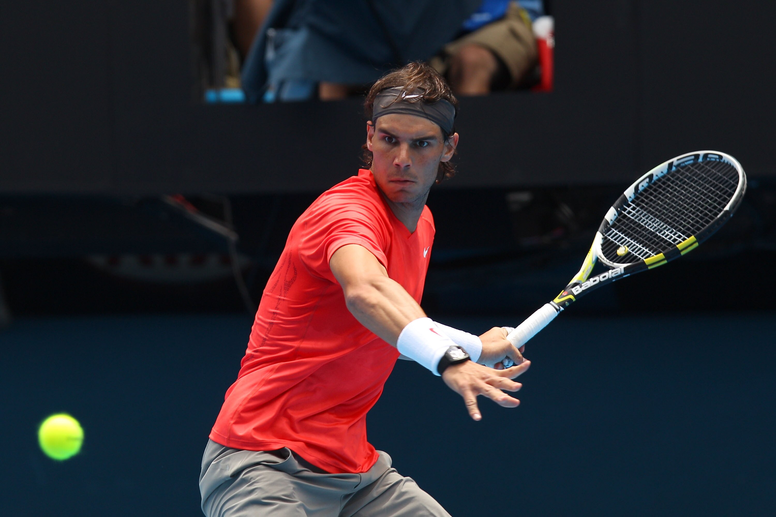 MELBOURNE, AUSTRALIA - JANUARY 18: Rafael Nadal of Spain plays a forehand in his first round match against Marcos Daniel of Brazil during day two of the 2011 Australian Open at Melbourne Park on January 18, 2011 in Melbourne, Australia. (Photo by Mark Dad
