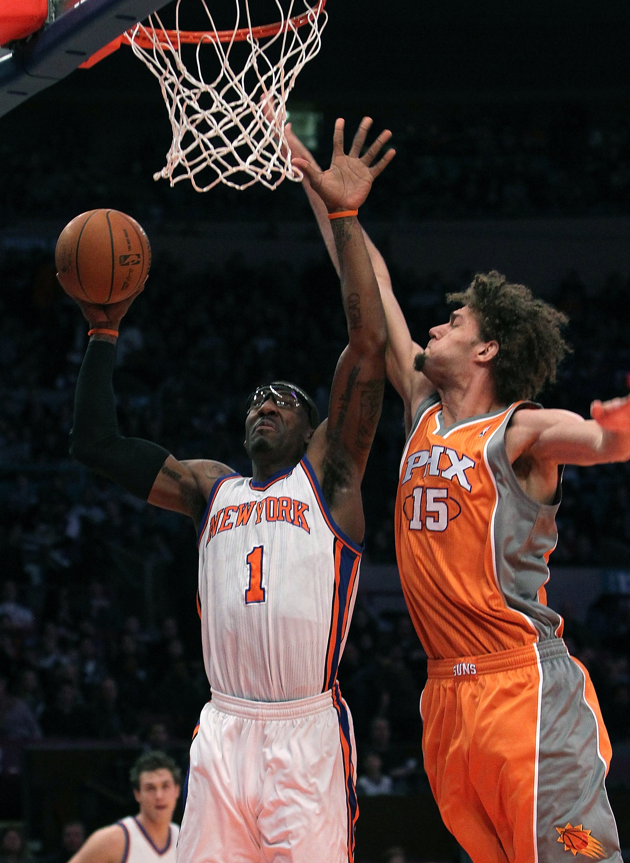 NEW YORK, NY - JANUARY 17:  Amar'e Stoudemire #1 of the New York Knicks shoots the ball against Robin Lopez #15 of the Phoenix Suns at Madison Square Garden on January 17, 2011 in New York City. NOTE TO USER: User expressly acknowledges and agrees that, b