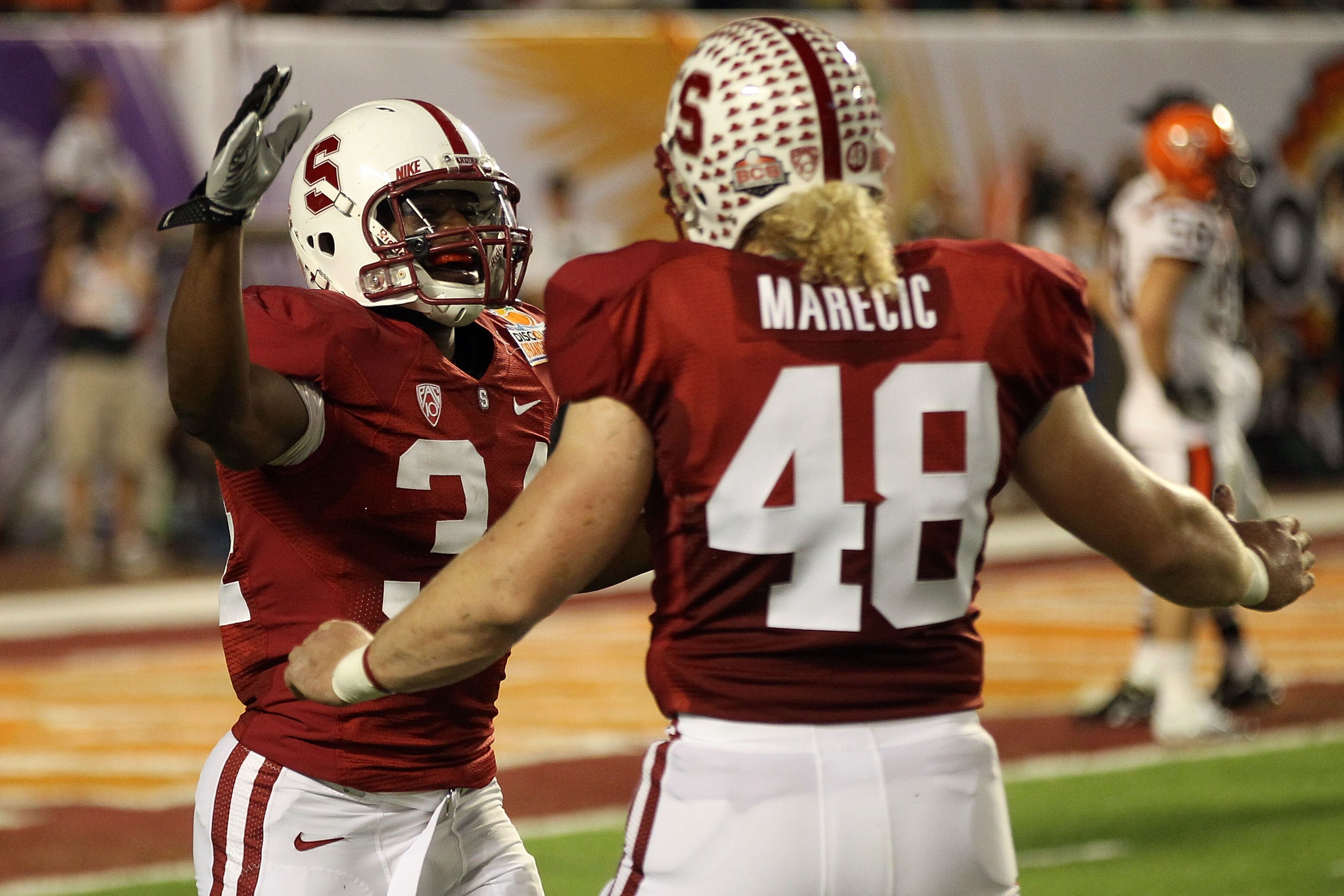 MIAMI, FL - JANUARY 03:  (L-R) Jeremy Stewart #34 and Owen Marecic #48 of the Stanford Cardinal celebrate after Stewart scored a 60-yard rushing touchdown in the first quarter against the Virginai Tech Hokies during the 2011 Discover Orange Bowl at Sun Li