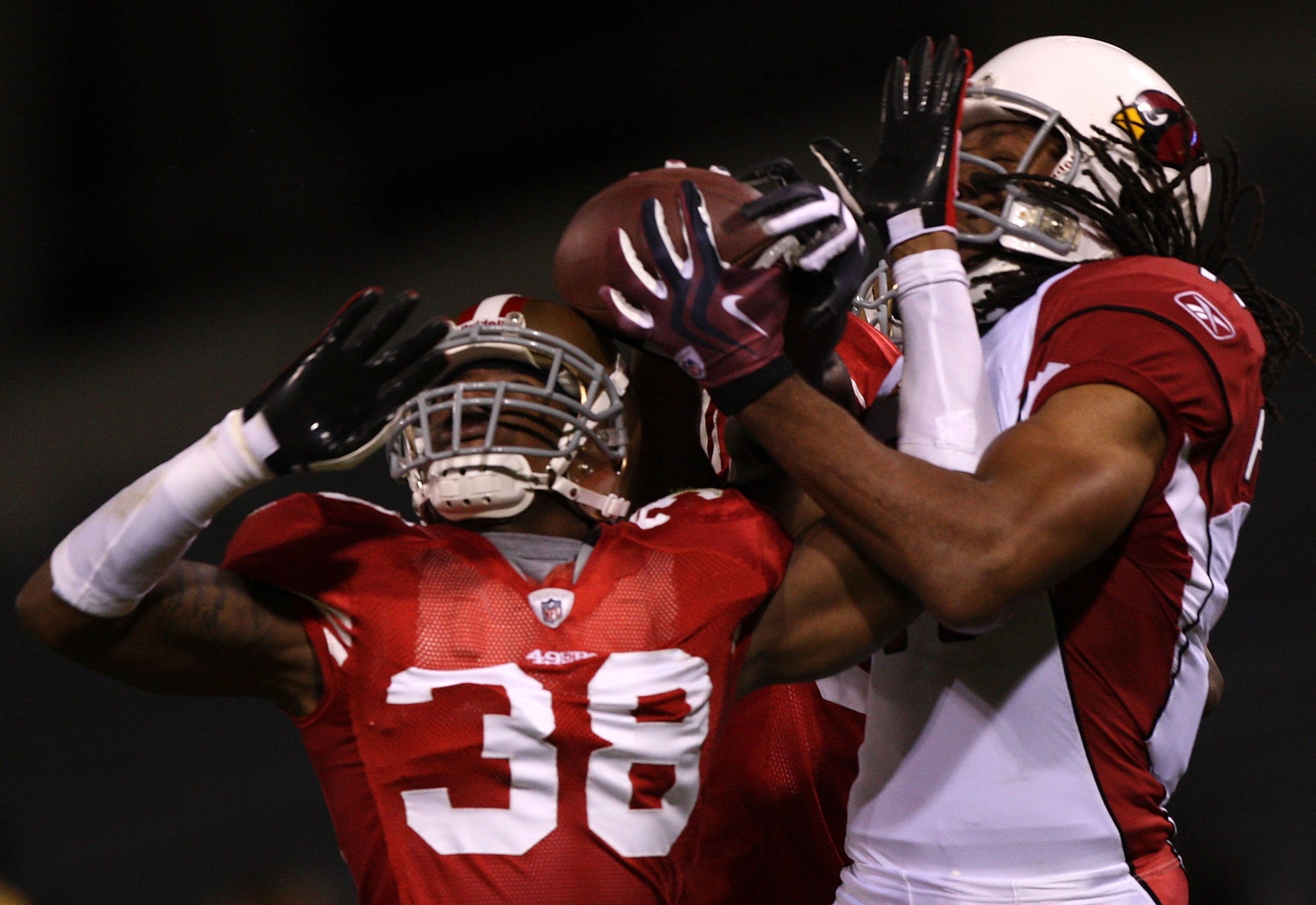 SAN FRANCISCO - DECEMBER 14:  Wide receiver Larry Fitzgerald #11 of the Arizona Cardinals misses a pass as it is broken up by Dashon Goldson #38 of the San Francisco 49ers in the first half at Candlestick Park on December 14, 2009 in San Francisco, Califo