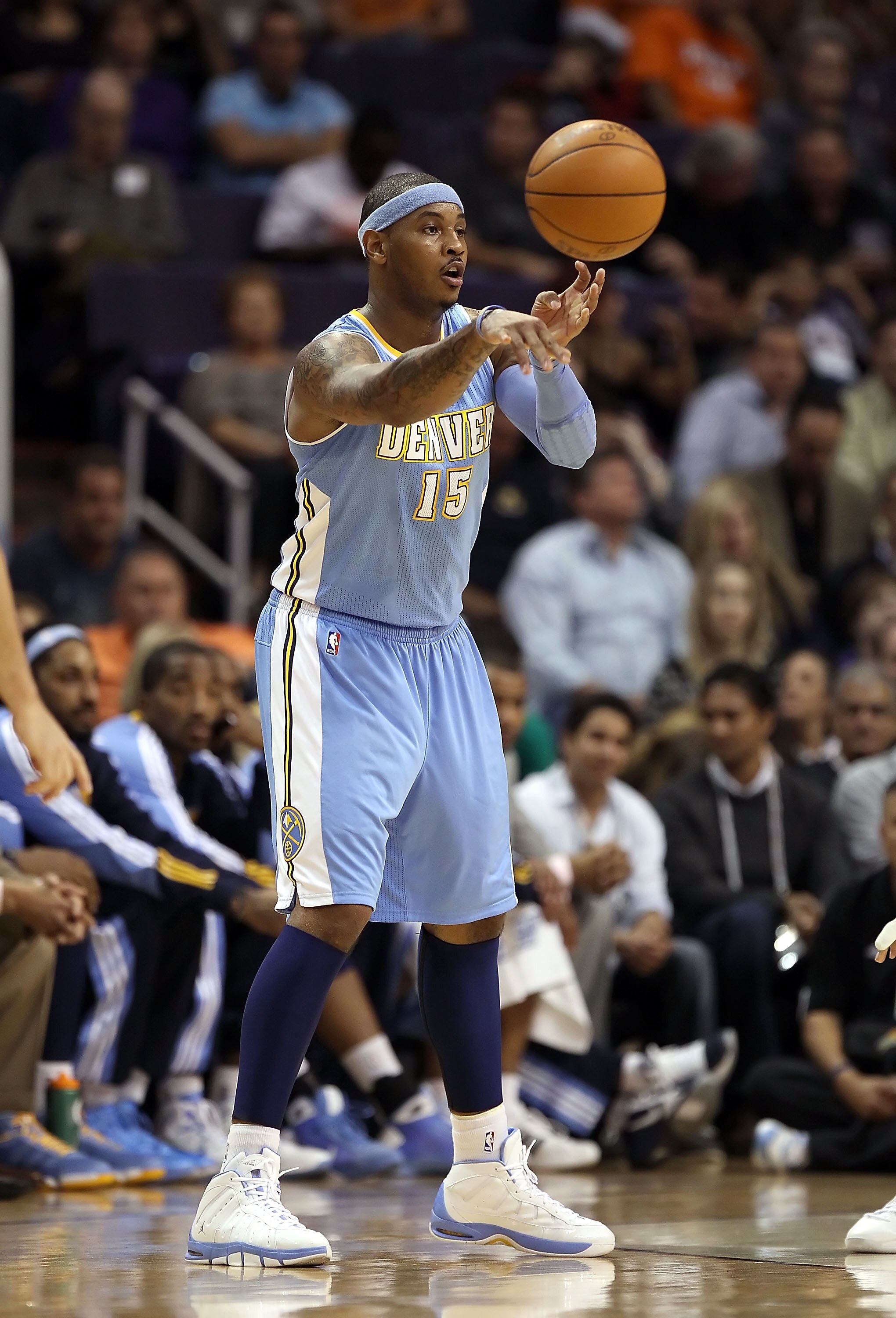 PHOENIX - NOVEMBER 15:  Carmelo Anthony #15 of the Denver Nuggets passes the ball during the NBA game against the Phoenix Suns at US Airways Center on November 15, 2010 in Phoenix, Arizona.  The Suns defeated the Nuggets 100-94.  NOTE TO USER: User expres