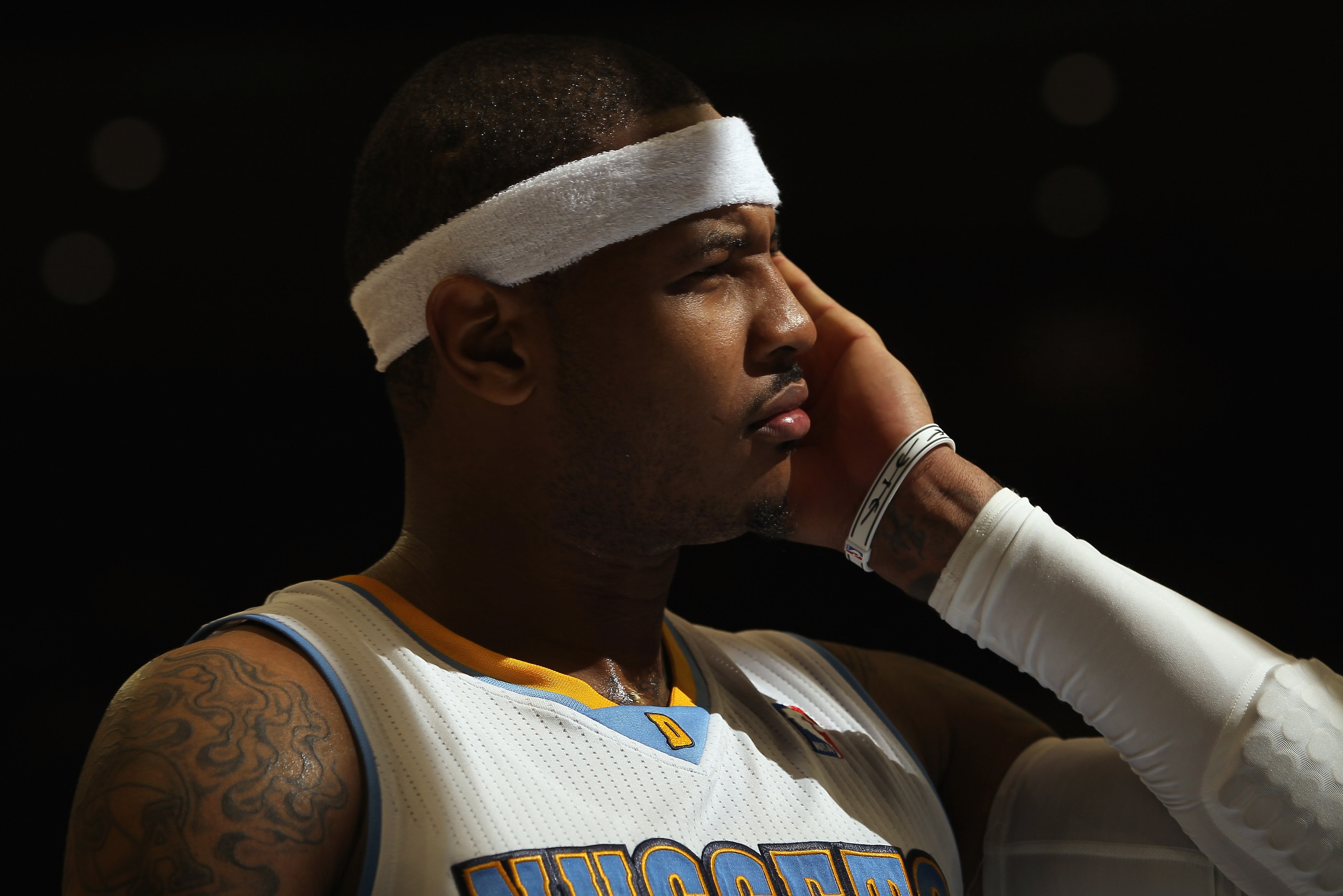 DENVER - NOVEMBER 16: Carmelo Anthony #15 of the Denver Nuggets looks on during a break in the action against the New York Knicks at the Pepsi Center on November 16, 2010 in Denver, Colorado. The Nuggets defeated the Knicks 120-118. NOTE TO USER: User ex DENVER - NOVEMBER 16: Carmelo Anthony #15 of the Denver Nuggets looks on during a break in the action against the New York Knicks at the Pepsi Center on November 16, 2010 in Denver, Colorado. The Nuggets defeated the Knicks 120-118. NOTE TO USER: User ex