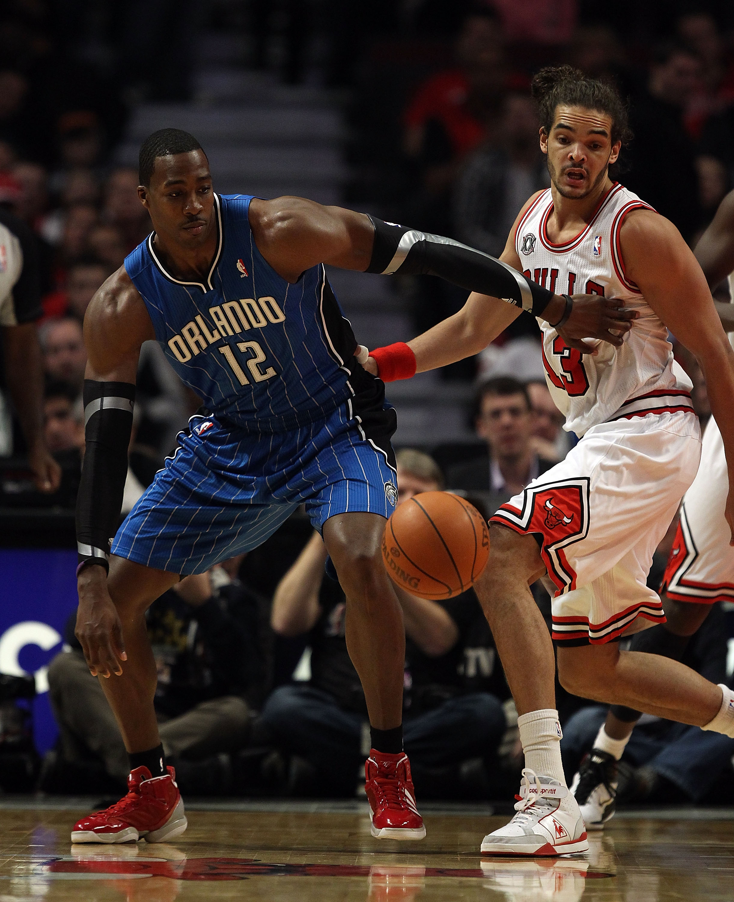 CHICAGO, IL - DECEMBER 01: Dwight Howard #12 of the Orlando Magic and Joakim Noah #13 of the Chicago Bulls moves toward a loose ball at the United Center on December 1, 2010 in Chicago, Illinois. The Magic defeated the Bulls 107-78. NOTE TO USER: User exp