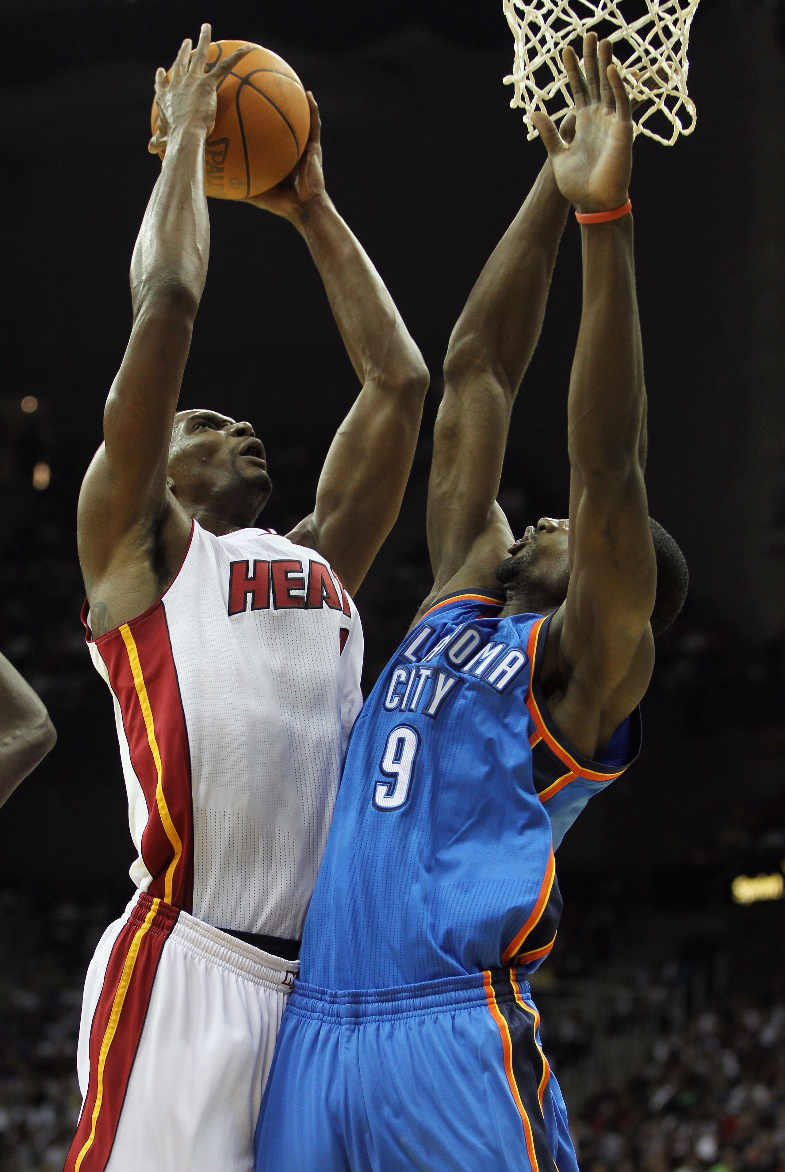 KANSAS CITY, MO - OCTOBER 08:  Chris Bosh #1 of the Miami Heat shoots over Serge Ibaka #9 of the Oklahoma City Thunder during the game on October 8, 2010 at the Sprint Center in Kansas City, Missouri.  (Photo by Jamie Squire/Getty Images)