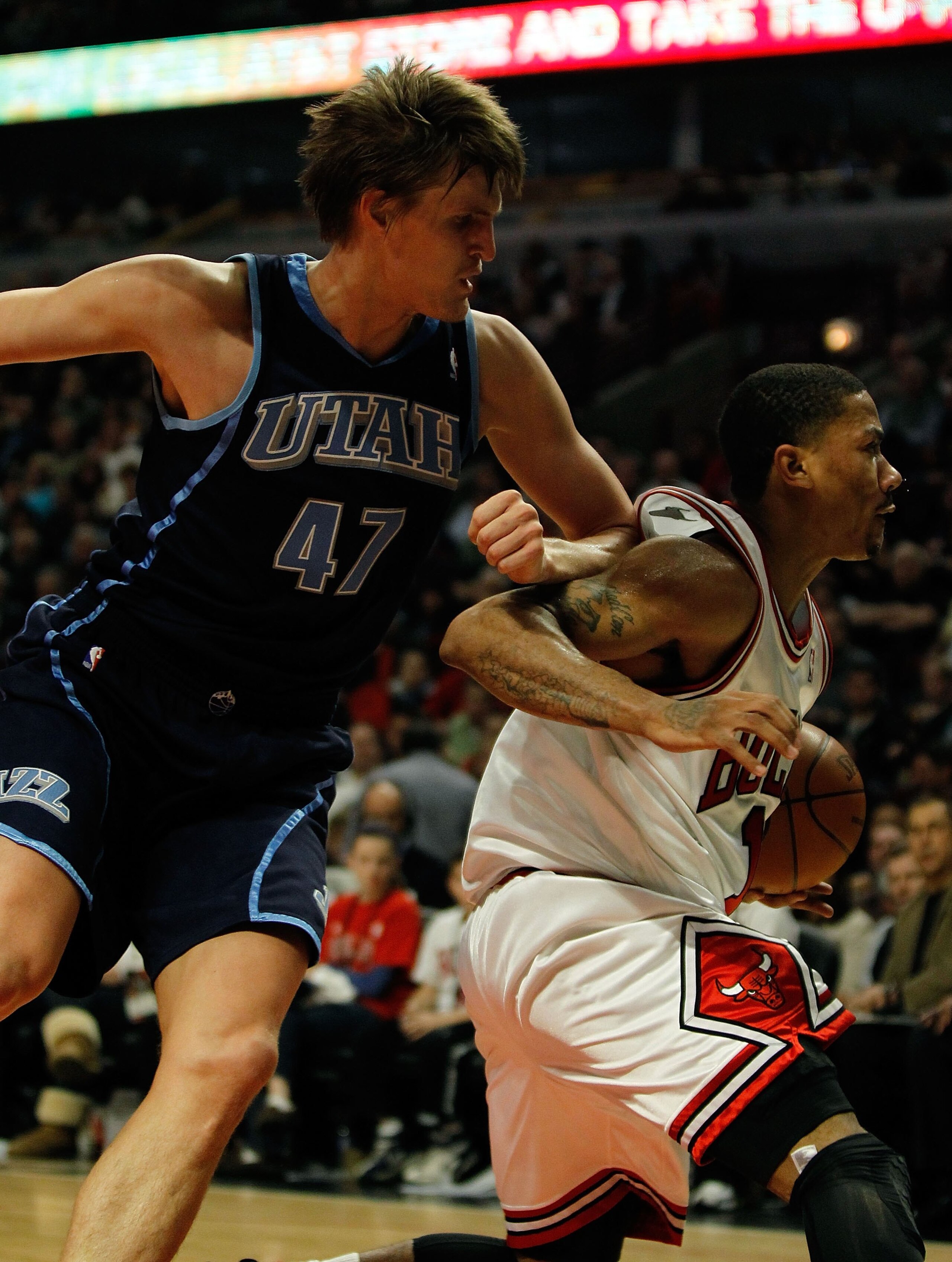 CHICAGO - MARCH 09: Andrei Kirilenko #47 of the Utah Jazz knocks Derrick Rose #1 of the Chicago Bulls in the back with his elbow at the United Center on March 9, 2010 in Chicago, Illinois. The Jazz defeated the Bulls 132-108. NOTE TO USER: User expressly