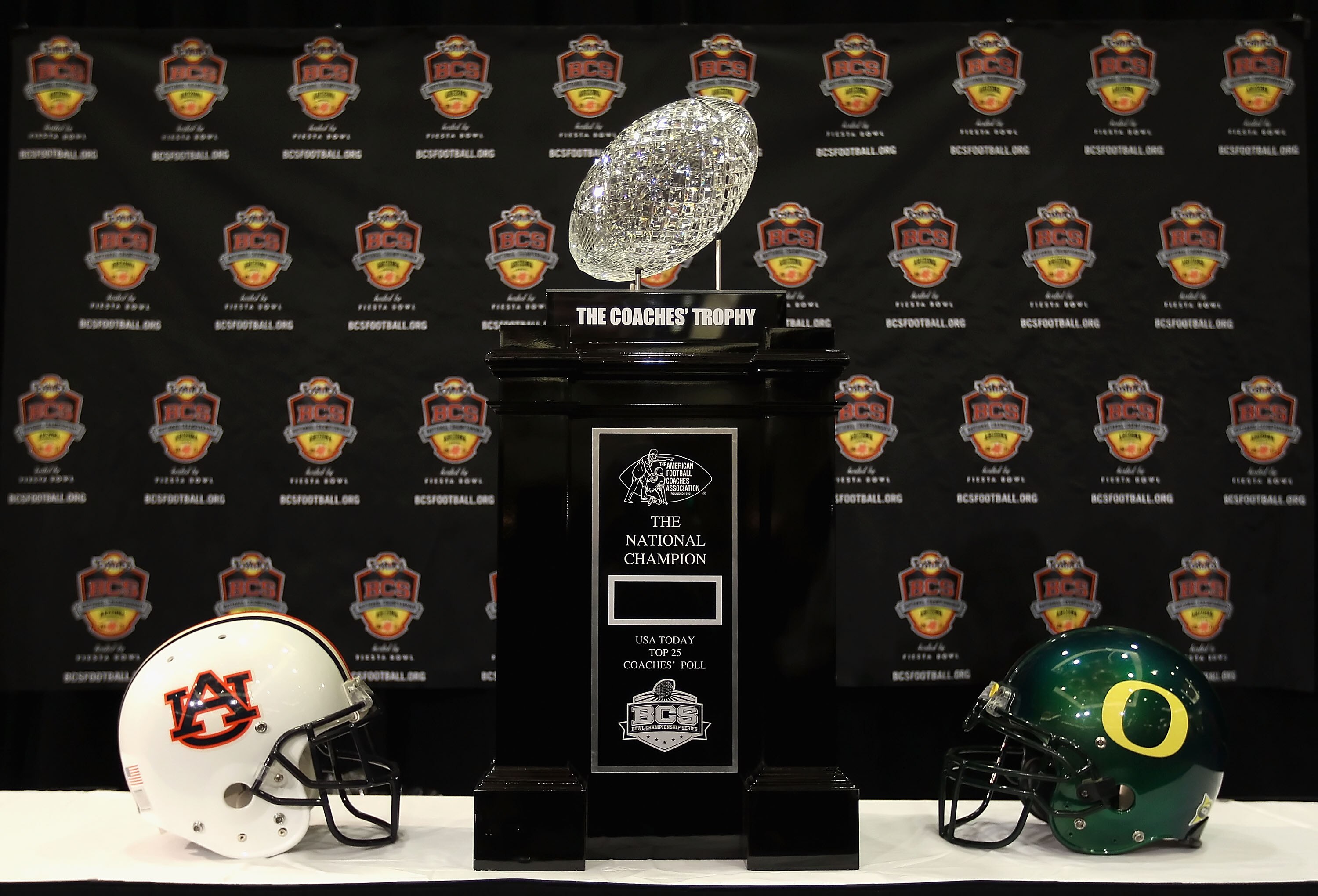 SCOTTSDALE, AZ - JANUARY 07:  The coaches trophy is displayed with helmets for the Auburn Tigers and the Oregon Ducks during Media Day for the Tostitos BCS National Championship Game at the JW Marriott Camelback Inn on January 7, 2011 in Scottsdale, Arizo