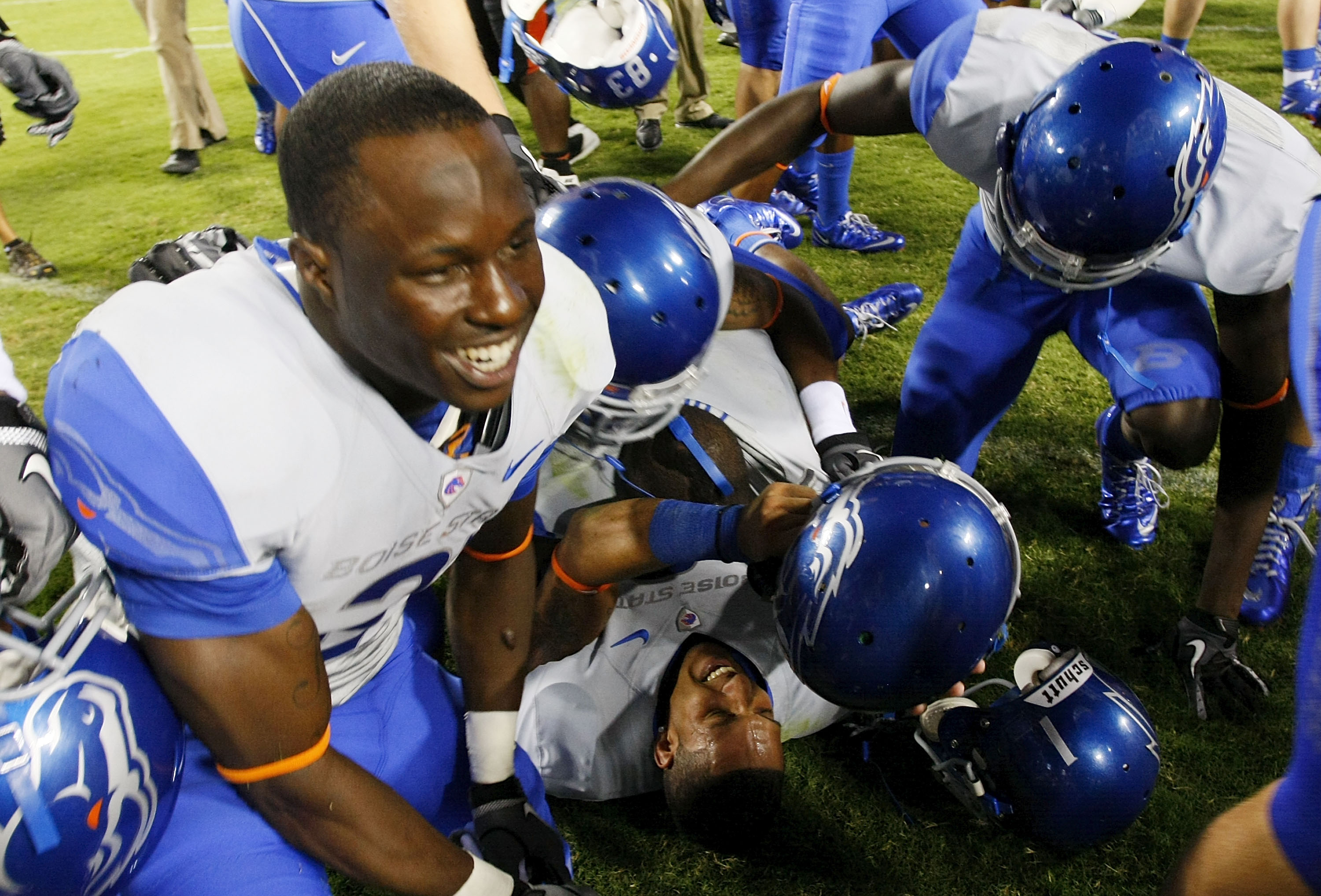 LANDOVER, MD - SEPTEMBER 06:  Wide reciever Austin Pettis (bottom) of the Boise State Broncos is mobbed by teammates after the Broncos defeated the Virginia Tech Hokies 33-30  at FedExField on September 6, 2010 in Landover, Maryland.  (Photo by Geoff Burk