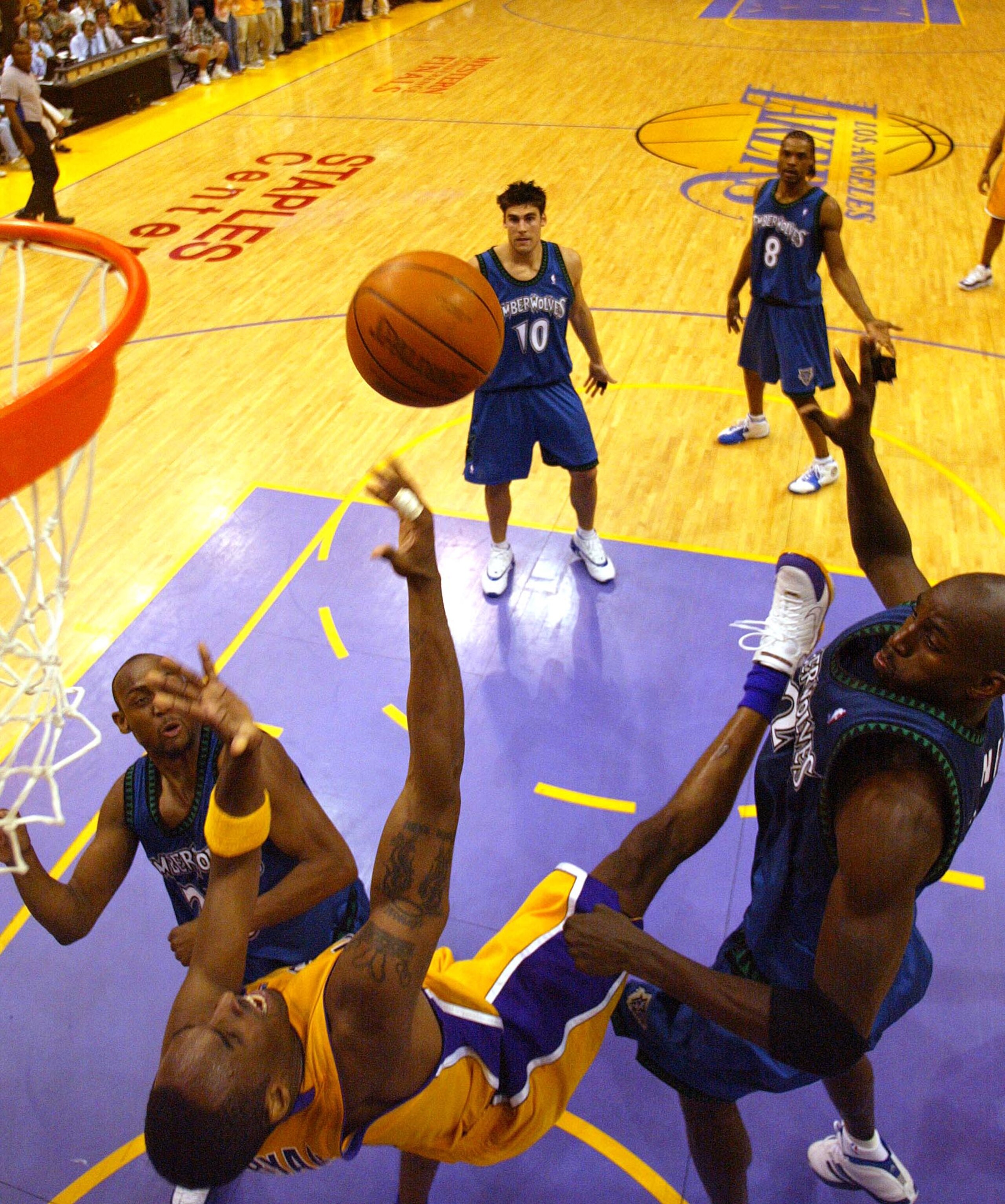 LOS ANGELES - MAY 31:  Kobe Bryant #8 of the Los Angeles Lakers goes to the basket against Kevin Garnett #8 of the Minnesota Timberwolves in Game six of the Western Conference Finals during the 2004 NBA Playoffs on May 31, 2004 at Staples Center in Los An
