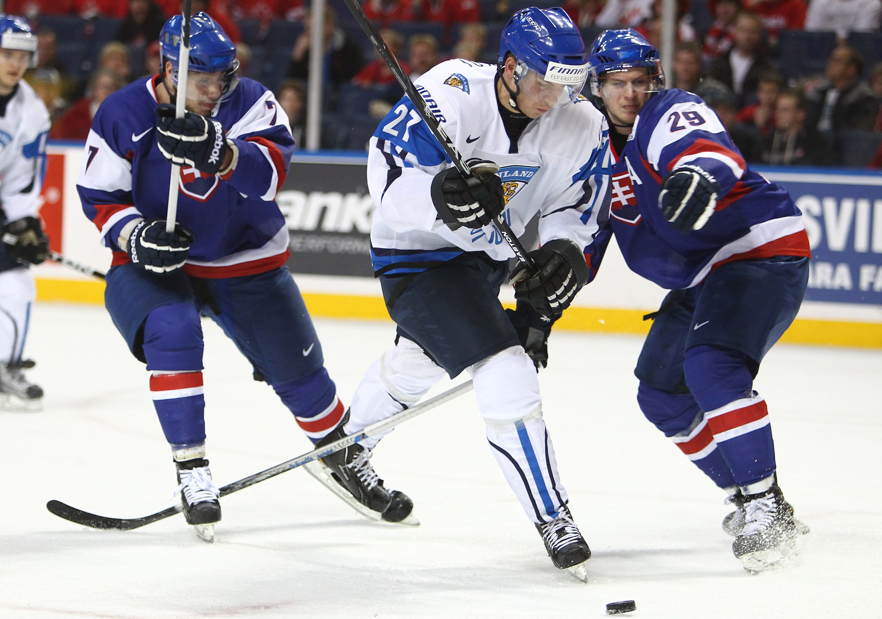BUFFALO, NY - DECEMBER 31: Forward Joonas Donskoi #27 of Finland gets past forward Miroslav Preisinger #29 of Slovakia during the 2011 IIHF World U20 Championship game between Slovakia and Finland on December 31, 2010 at HSBC Arena in Buffalo, New York. (