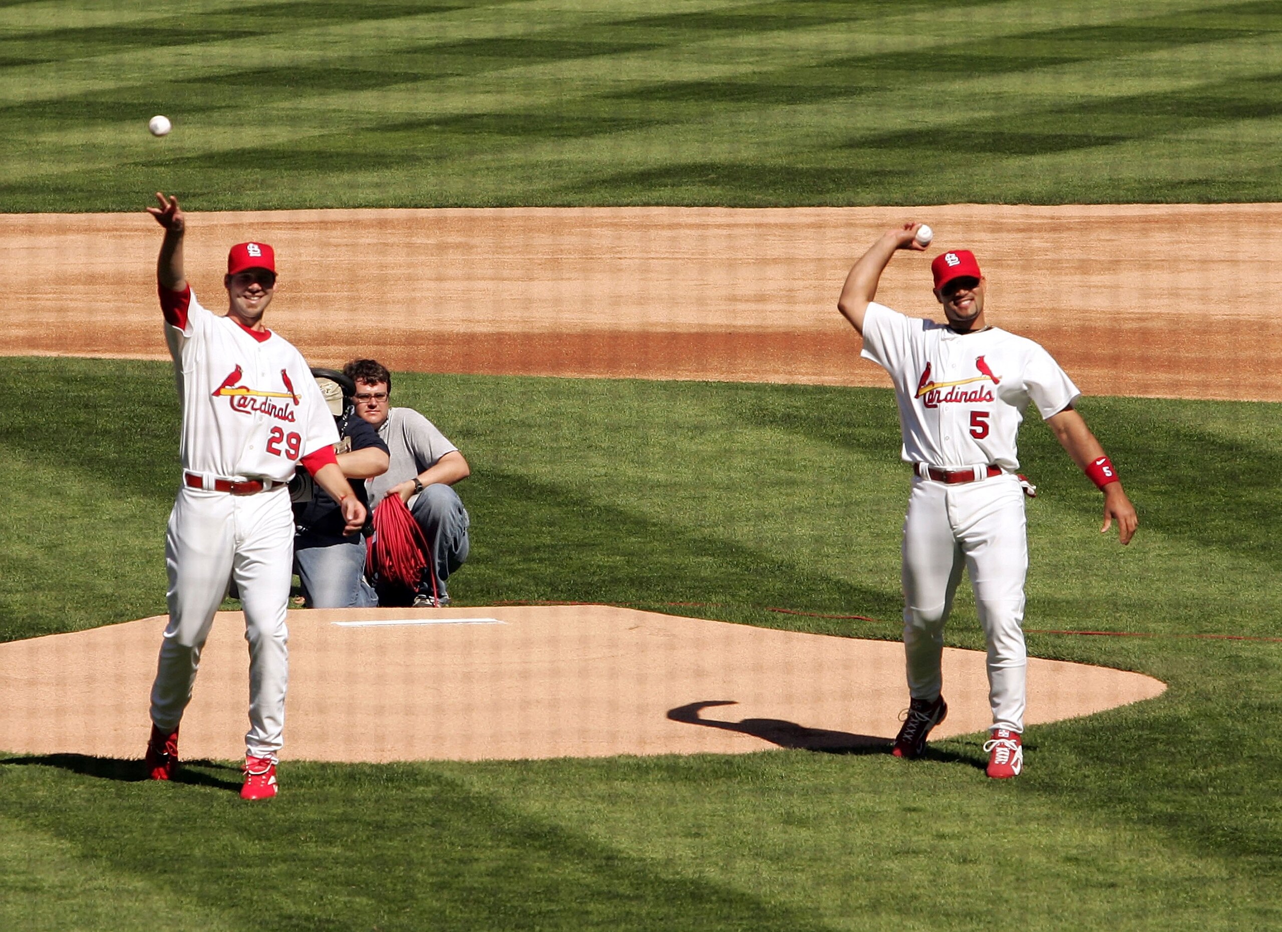 ST. LOUIS - APRIL 10: Chris Carpenter #29 and Albert Pujols #5 of the St. Louis Cardinals throw out the ceremonial first pitch before the game against the Milwaukee Brewers in the season opener and first Major League Baseball game in the new stadium on A ST. LOUIS - APRIL 10: Chris Carpenter #29 and Albert Pujols #5 of the St. Louis Cardinals throw out the ceremonial first pitch before the game against the Milwaukee Brewers in the season opener and first Major League Baseball game in the new stadium on A