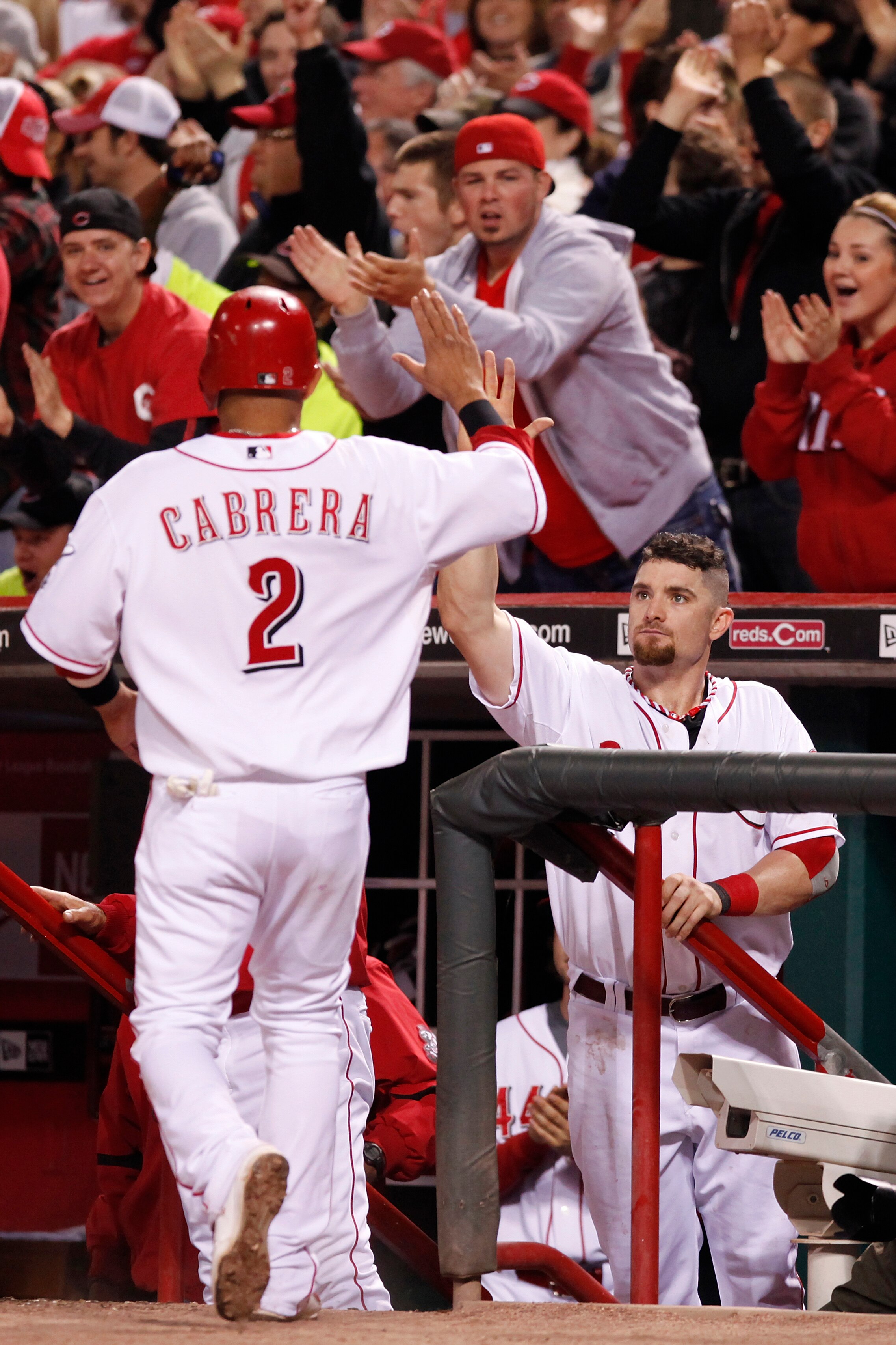 CINCINNATI, OH - SEPTEMBER 28: Jonny Gomes #31 of the Cincinnati Reds greets Orlando Cabrera #2 after he scored the tying run against the Houston Astros at Great American Ball Park on September 28, 2010 in Cincinnati, Ohio. The Reds won 3-2 to clinch the