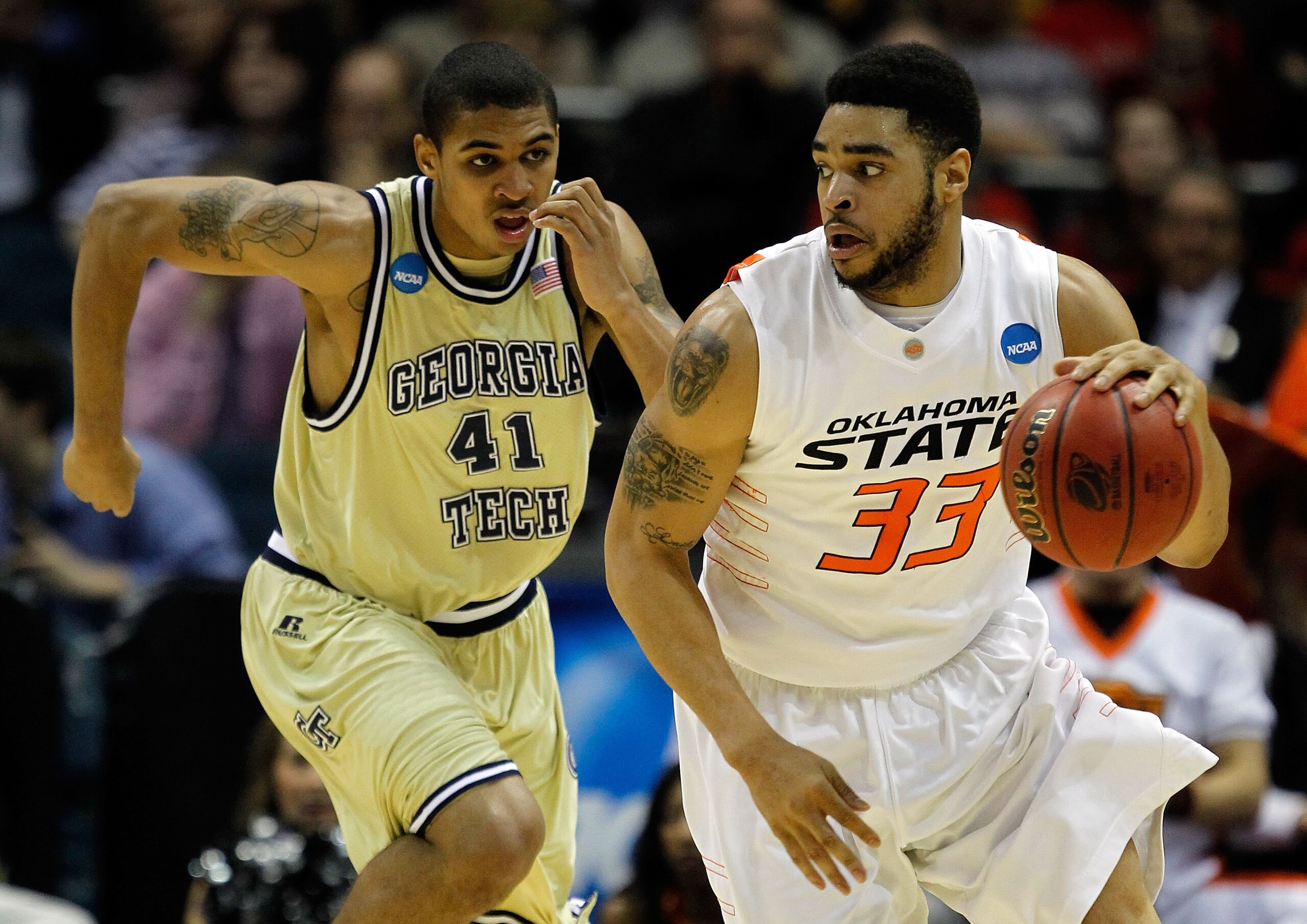 MILWAUKEE - MARCH 19:  Marshall Moses #33 of the Oklahoma State Cowboys moves the ball against Glen Rice Jr. #41 of the Georgia Tech Yellow Jackets in the first half during the first round of the 2010 NCAA men's basketball tournament at the Bradley Center
