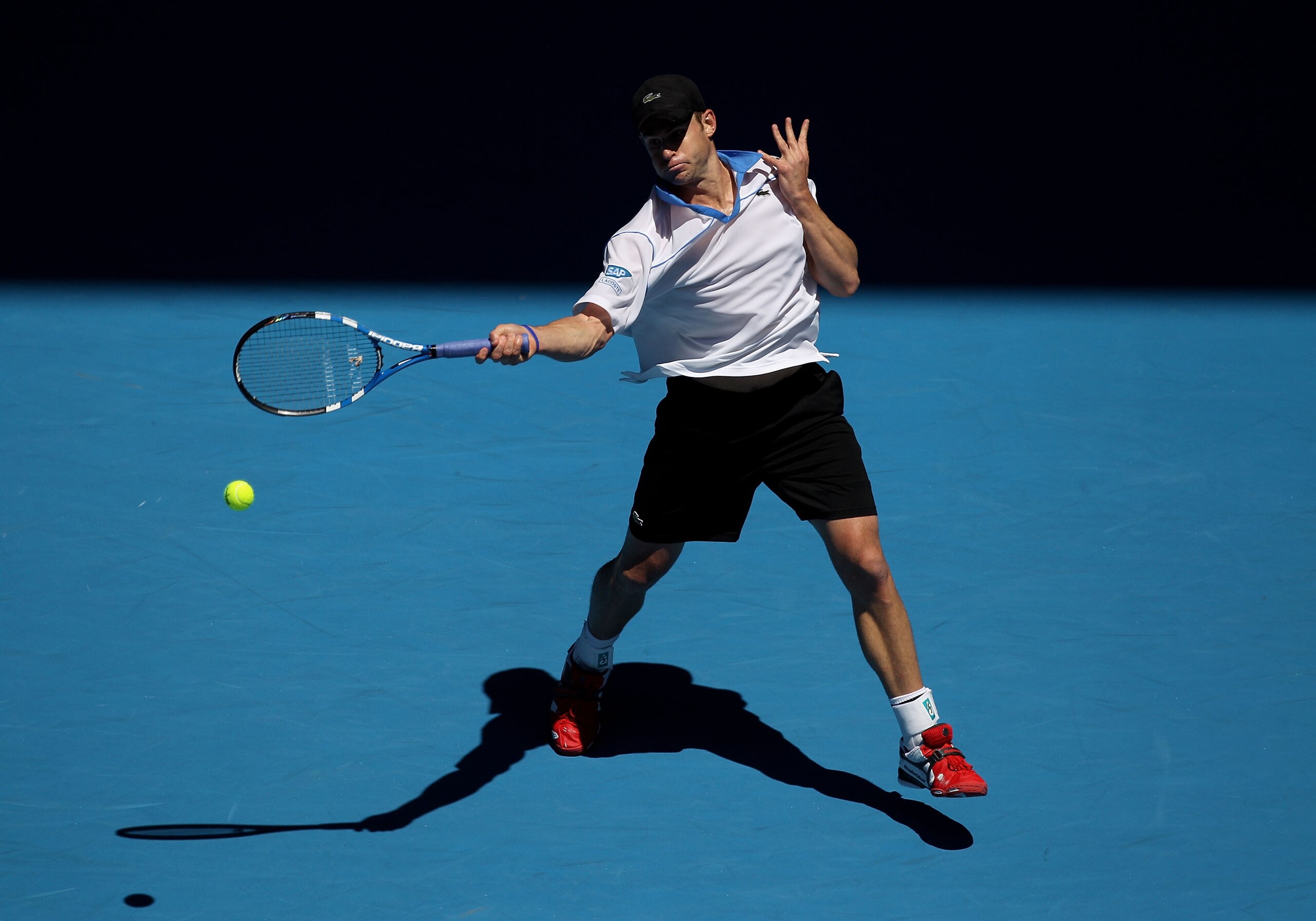 MELBOURNE, AUSTRALIA - JANUARY 19:  Andy Roddick of the United States of Americaplays a forehand in his second round match against Igor Kunitsyn of Russia during day three of the 2011 Australian Open at Melbourne Park on January 19, 2011 in Melbourne, Aus