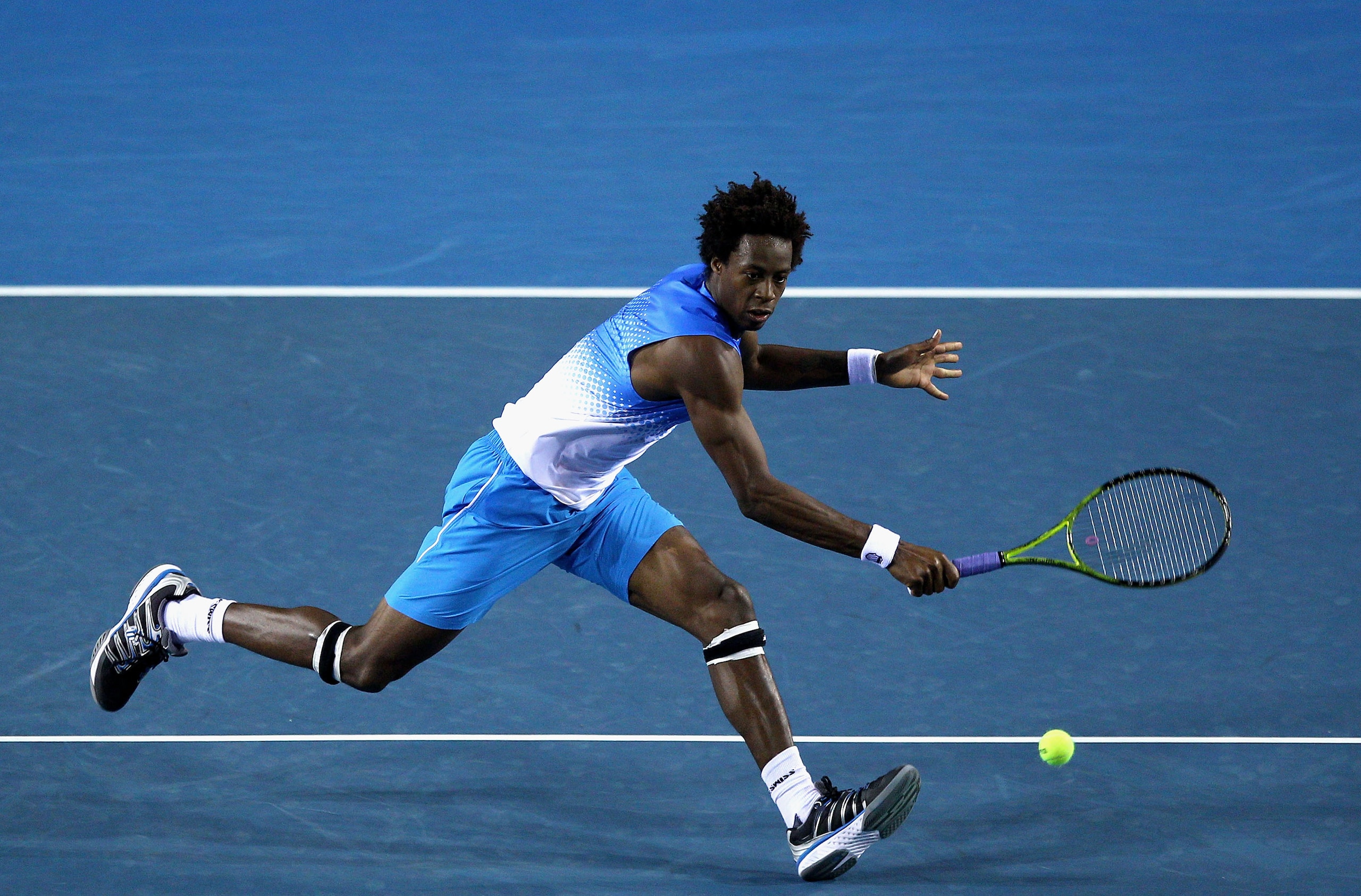 MELBOURNE, AUSTRALIA - JANUARY 19:  Gael Monfils of France plays a backhand in his second round match against Frederico Gil of Portugal during day three of the 2011 Australian Open at Melbourne Park on January 19, 2011 in Melbourne, Australia.  (Photo by