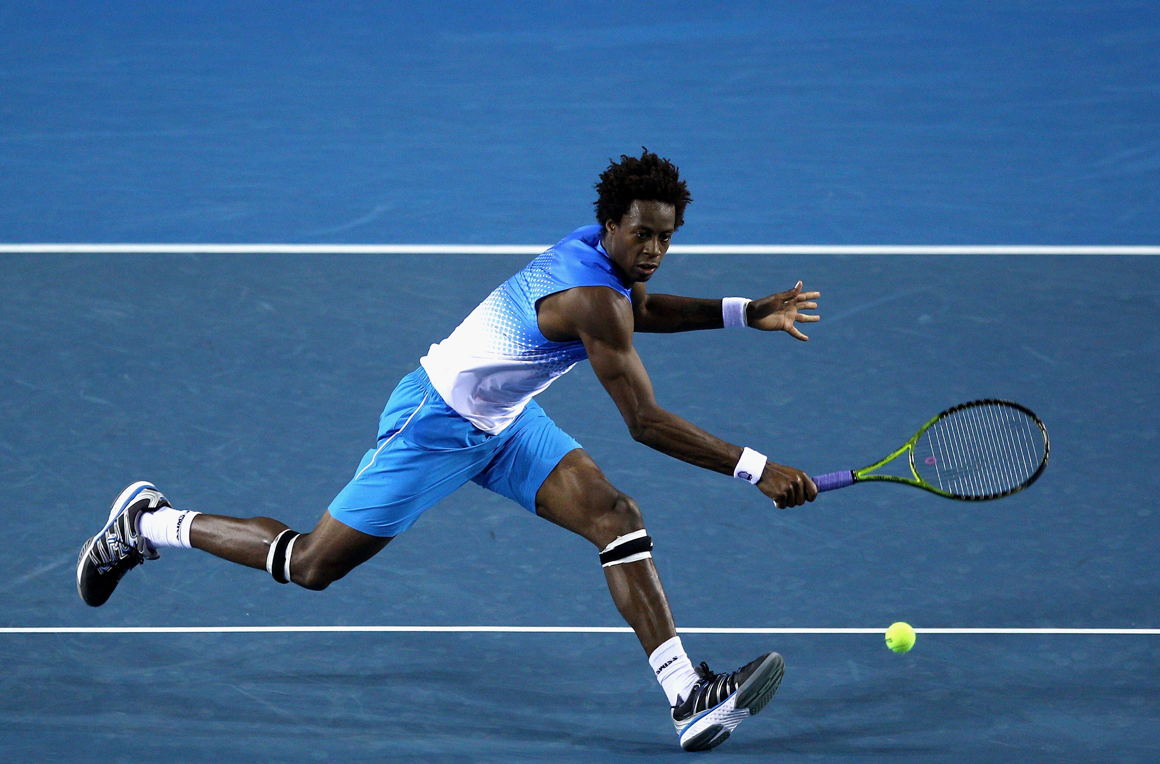 MELBOURNE, AUSTRALIA - JANUARY 19:  Gael Monfils of France plays a backhand in his second round match against Frederico Gil of Portugal during day three of the 2011 Australian Open at Melbourne Park on January 19, 2011 in Melbourne, Australia.  (Photo by