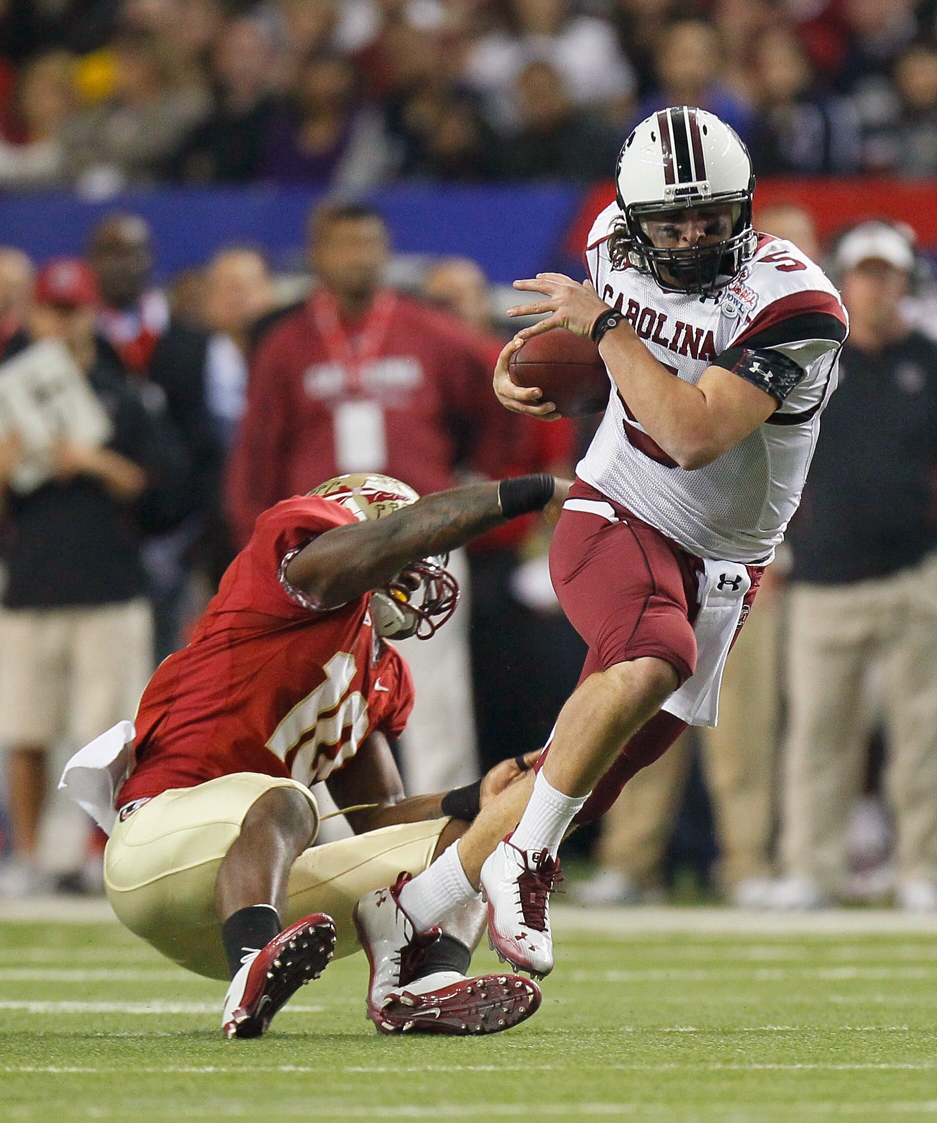 ATLANTA, GA - DECEMBER 31:  Nick Moody #10 of the Florida State Seminoles tackles quarterback Stephen Garcia #5 of the South Carolina Gamecocks during the 2010 Chick-fil-A Bowl at Georgia Dome on December 31, 2010 in Atlanta, Georgia.  (Photo by Kevin C. 