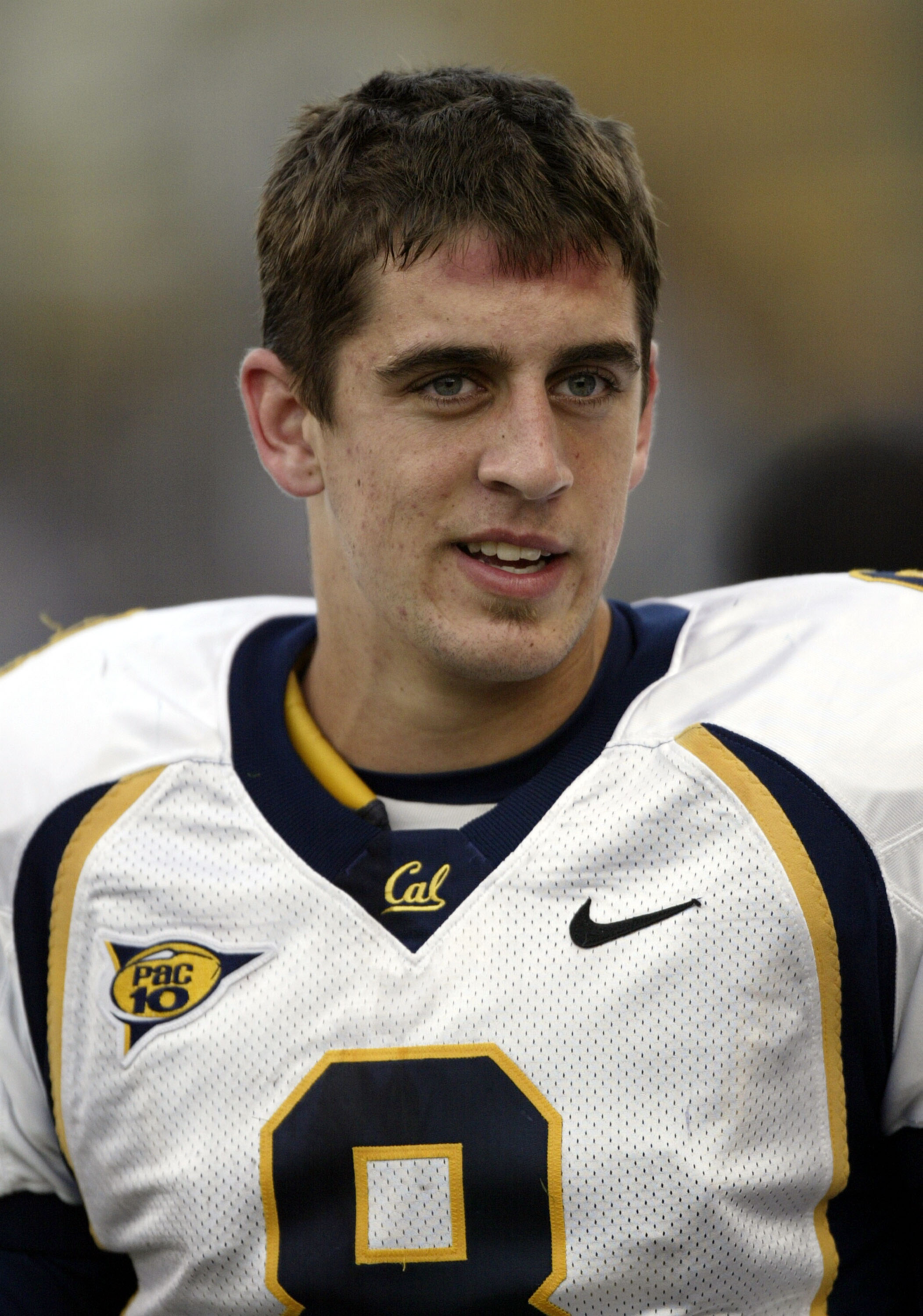 SEATTLE - NOVEMBER 13:  Quarterback Aaron Rodgers #8 of the California Golden Bears smiles on the sidelines near the end of the game against the Washington Huskies on November 13, 2004 at Husky Stadium in Seattle, Washington. The Bears beat the Huskies 42