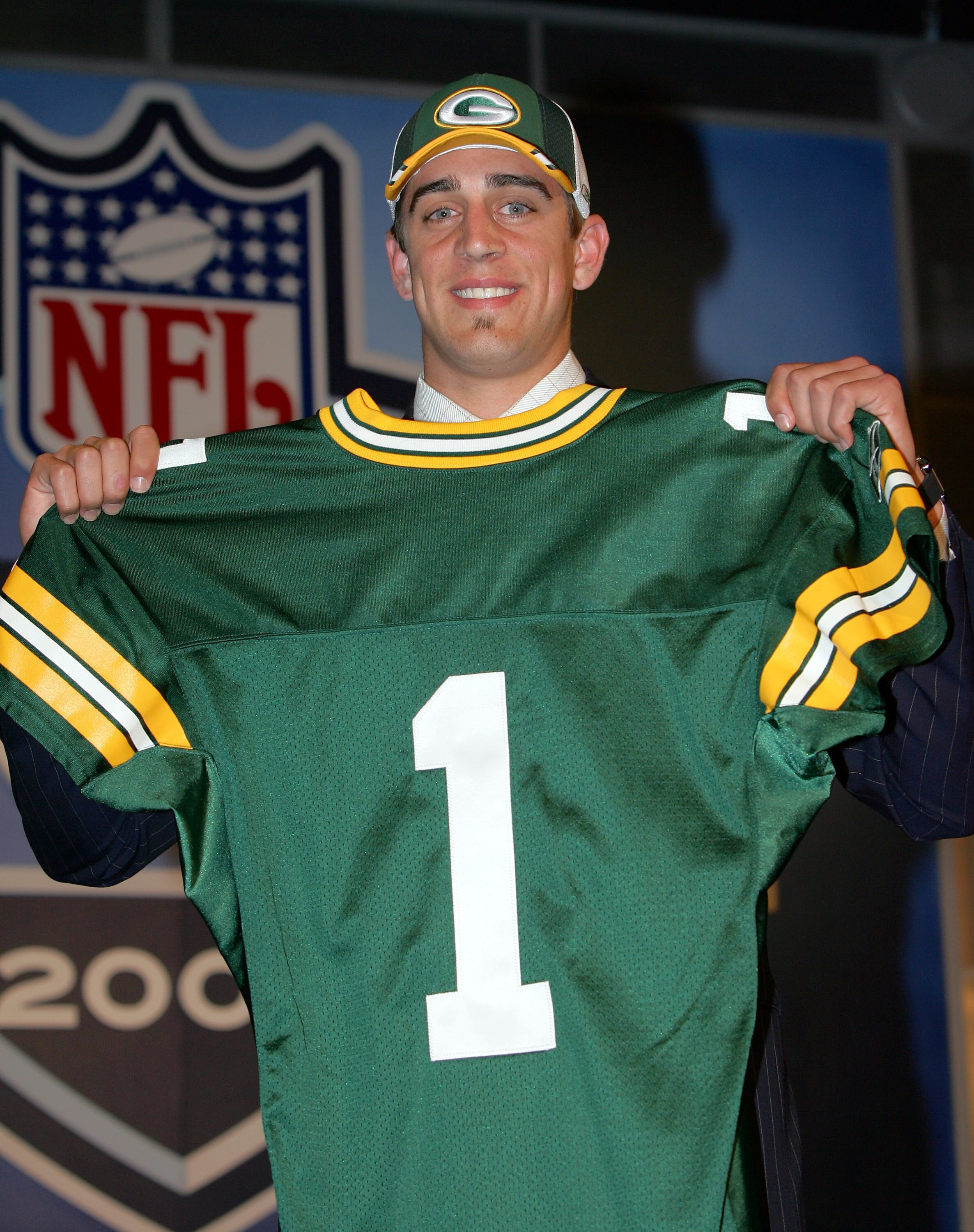 NEW YORK - APRIL 23:  Quarterback Aaron Rodgers (California) poses with his jersey after being drafted 24th overall by the Green Bay Packers during the 70th NFL Draft on April 23, 2005 at the Jacob K. Javits Convention Center in New York City.  (Photo by