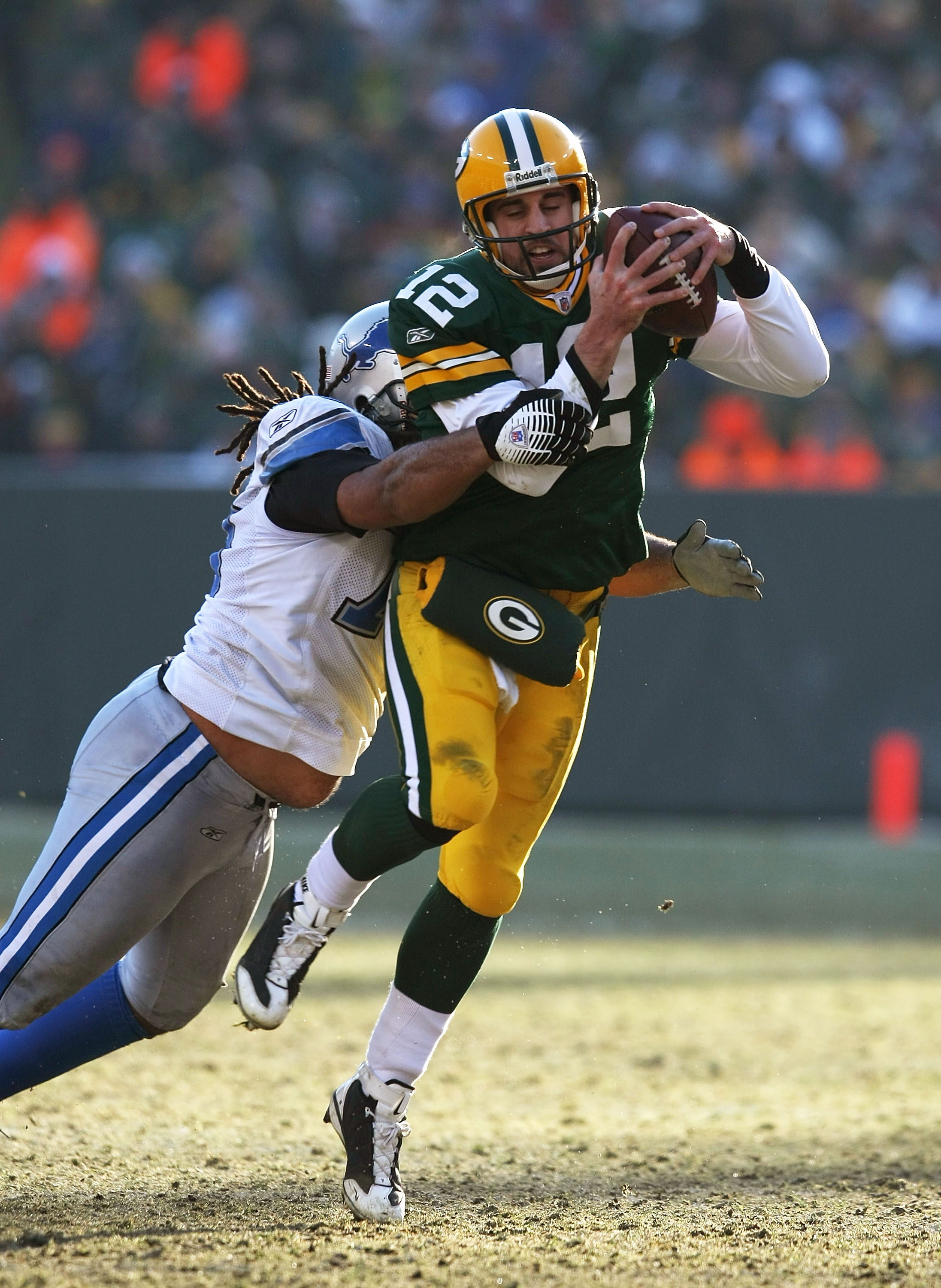 GREEN BAY, WI - DECEMBER 28: Aaron Rodgers #12 of the Green Bay Packers is brought down by Ikaika Alamam-Francis #97 of the Detroit Lions on December 28, 2008 at Lambeau Field in Green Bay, Wisconsin. The Packers defeated the Lions 31-21. (Photo by Jonath