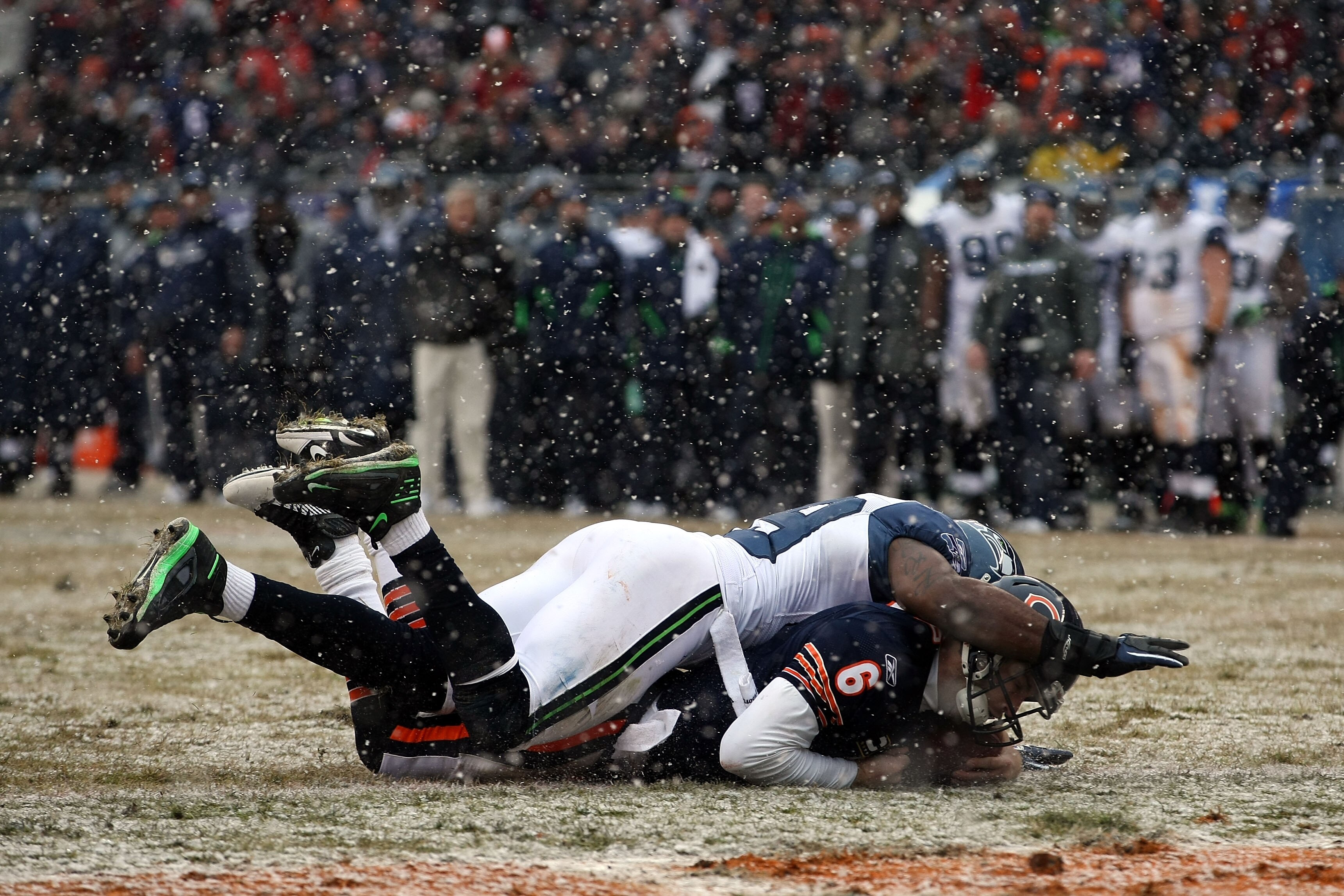 CHICAGO, IL - JANUARY 16:  Quarterback Jay Cutler #6 of the Chicago Bears dives into the endzone to score on a six-yard run against Aaron Curry #59 of the Seattle Seahawks in the second quarter of the 2011 NFC divisional playoff game at Soldier Field on J