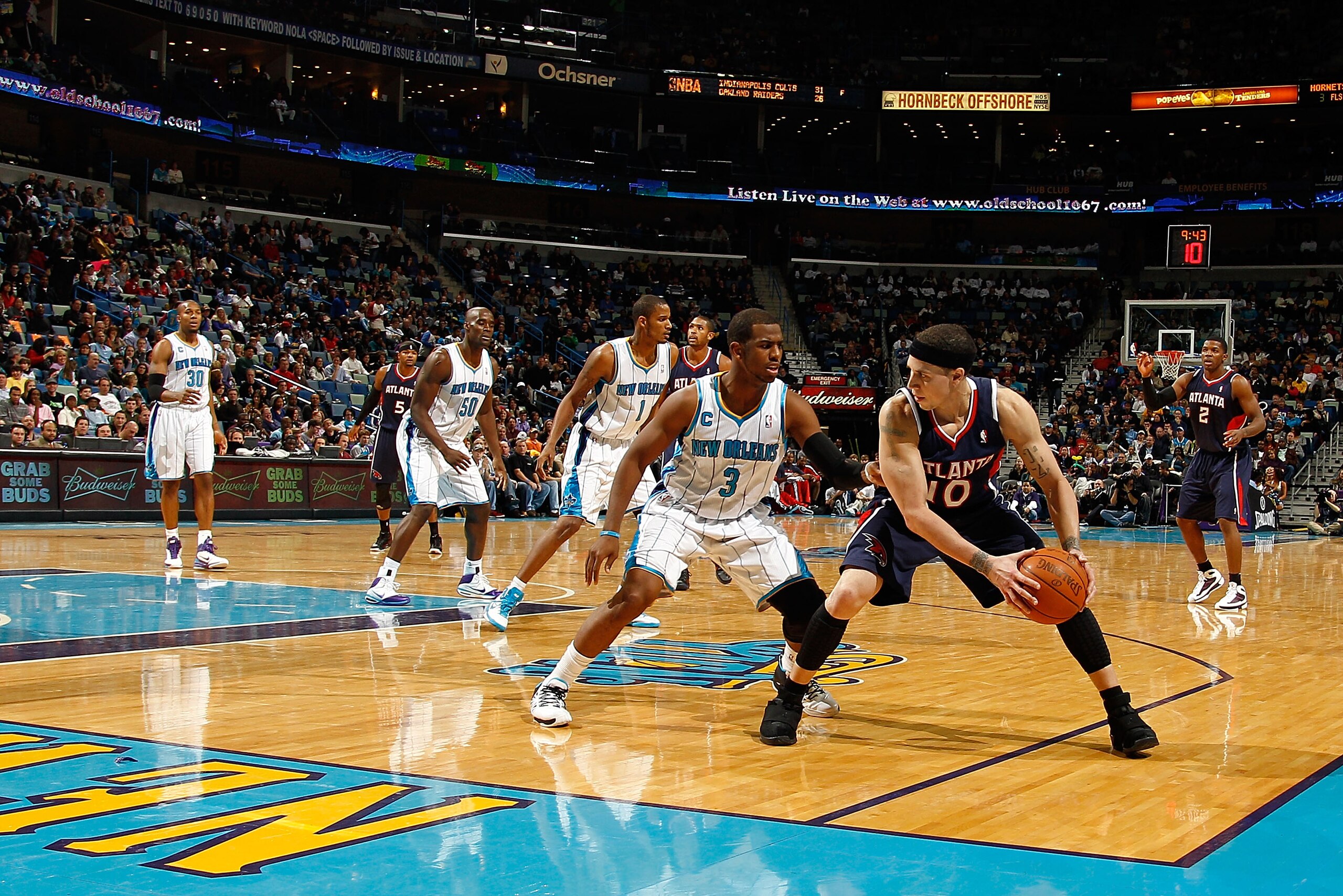 NEW ORLEANS, LA - DECEMBER 26:  Mike Bibby #10 of the Atlanta Hawks looks to pass the ball around Chris Paul #3  of the New Orleans Hornets at the New Orleans Arena on December 26, 2010 in New Orleans, Louisiana.  The Hornets defeated the Hawks 93-86.  NO
