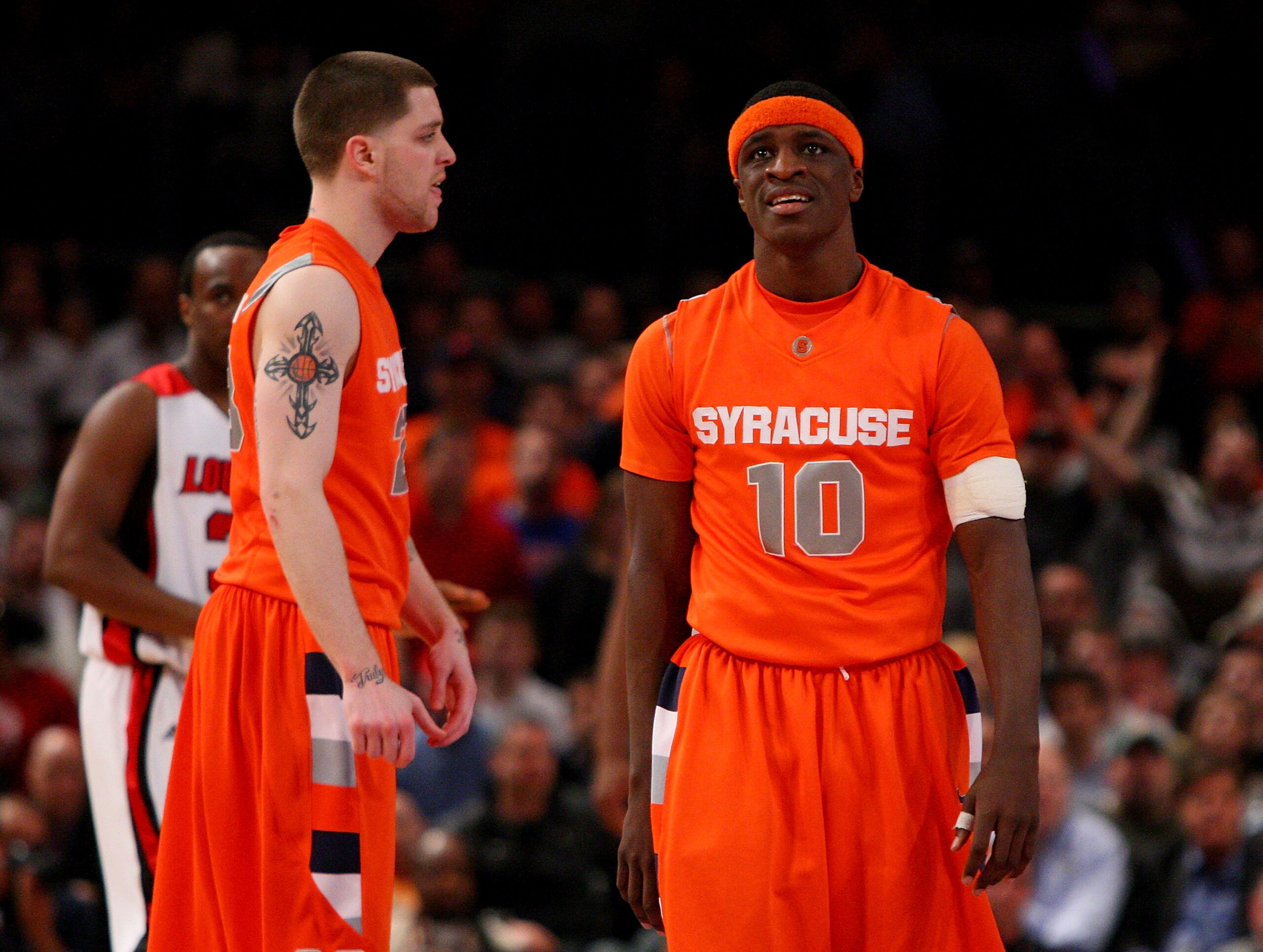 NEW YORK - MARCH 14: Eric Devendorf #23 and Jonny Flynn #10 of the Syracuse Orange look on near the end of the game against the Louisville Cardinals  during the championship game of the Big East Tournament at Madison Square Garden on March 14, 2009 in New