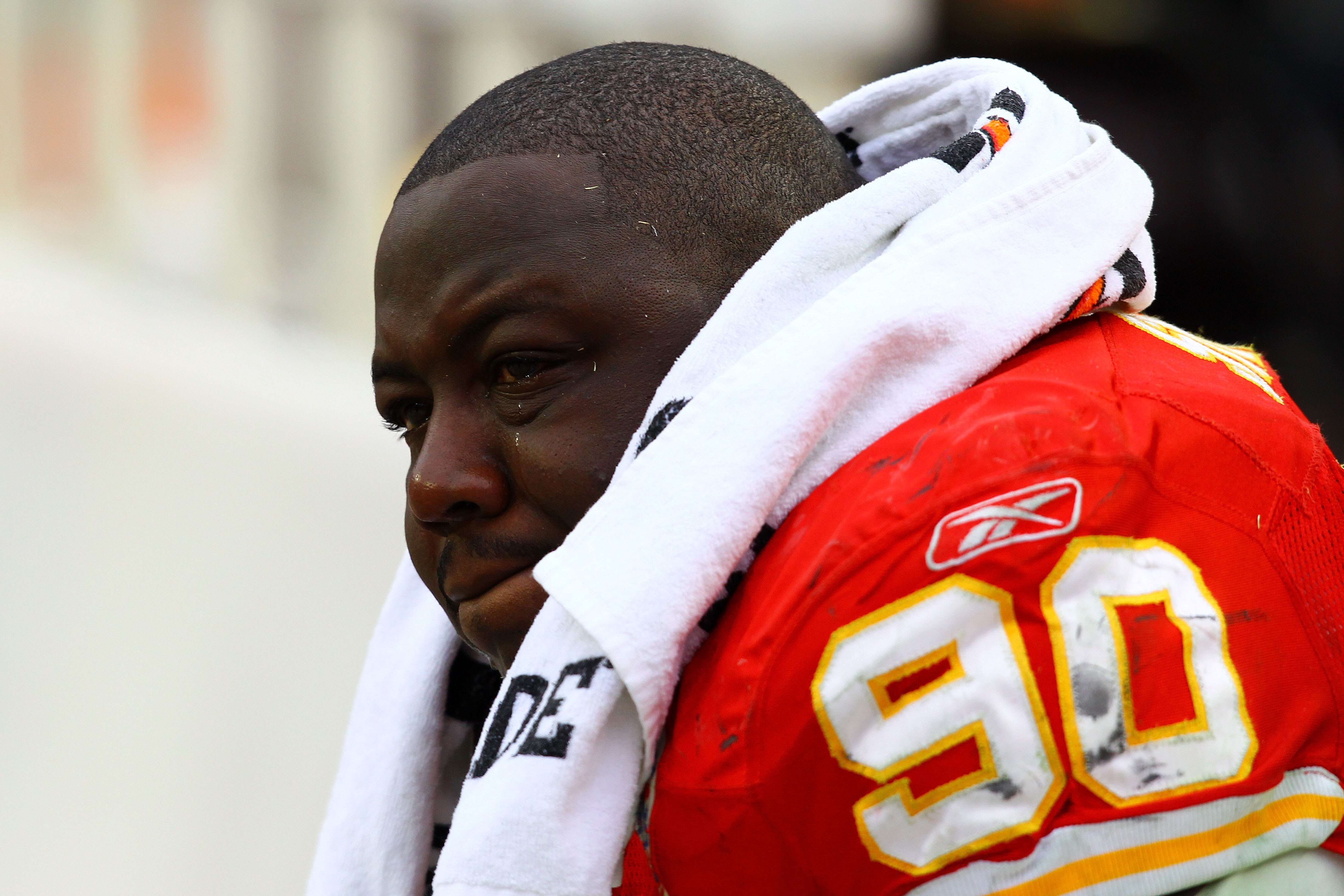 KANSAS CITY, MO - JANUARY 09:  Defensive tackle Shaun Smith #90 of the Kansas City Chiefs cries on the bench after losing 30-7 to of the Baltimore Ravens in the 2011 AFC wild card playoff game at Arrowhead Stadium on January 9, 2011 in Kansas City, Missou