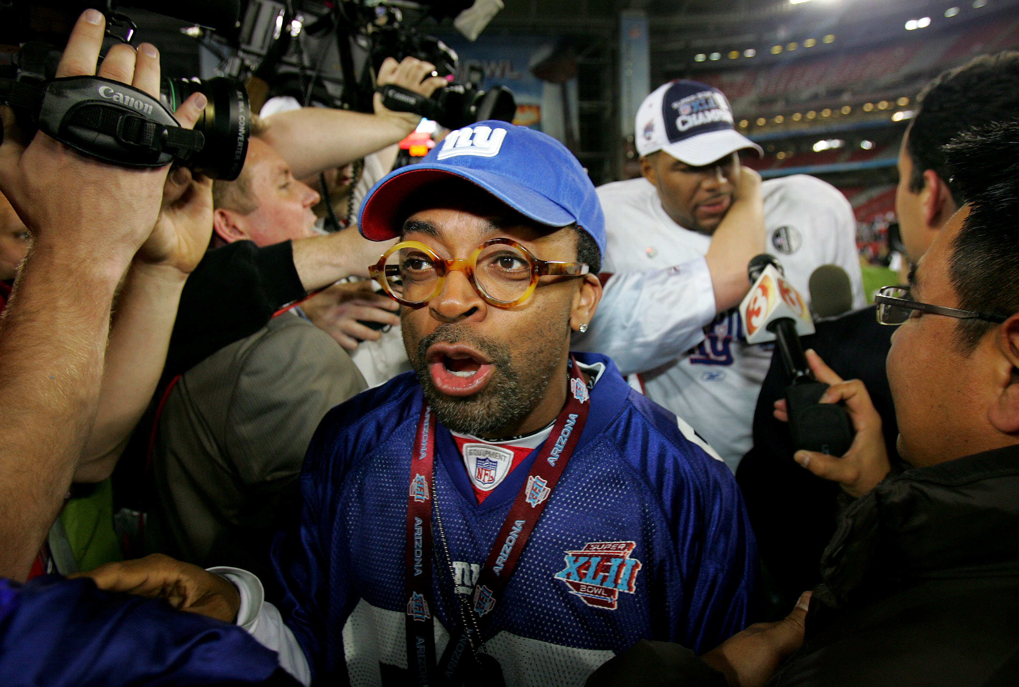GLENDALE, AZ - FEBRUARY 03:  Actor Spike Lee celebrates on the field after the New York Giants defeated the New England Patriots 17-14 after Super Bowl XLII on February 3, 2008 at the University of Phoenix Stadium in Glendale, Arizona.  (Photo by Streeter