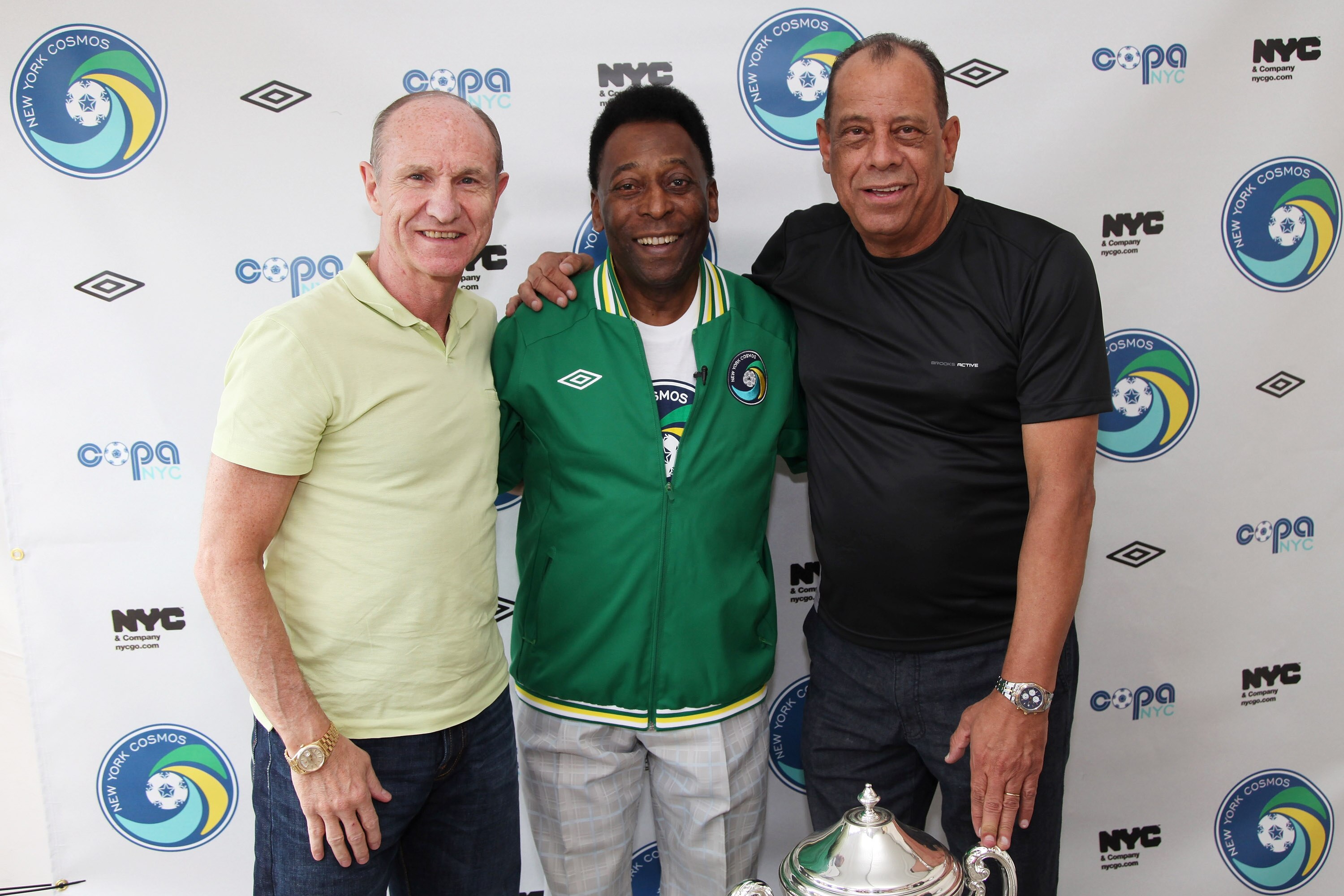 NEW YORK - AUGUST 01:  Soccer Legend Pele (C) and former team mates Dennis Tueart (L) and Carlos Alberto Torres (R)  pose for a photograph before the announcement of the return of the World Renowned New York Cosmos at Flushing Meadows Corona Park on Augus