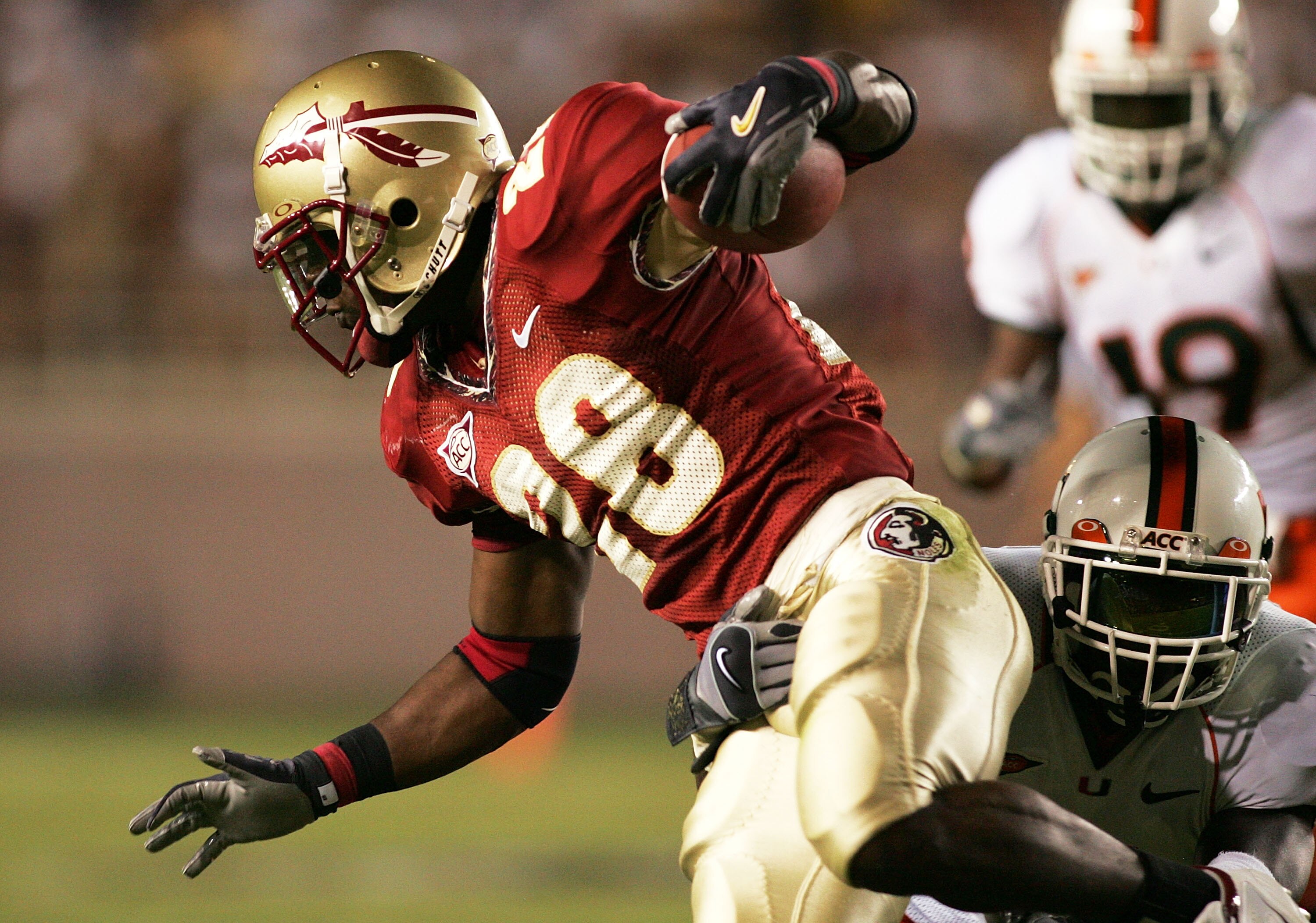 TALLAHASSEE, FL - SEPTEMBER 05:  Running back Lorenzo Booker #28 of the Florida State Seminoles avoids a tackle against the Miami Hurricanes at Doak Campbell Stadium on September 5, 2005 in Tallahassee, Florida. Florida State defeated Miami 10-7.  (Photo