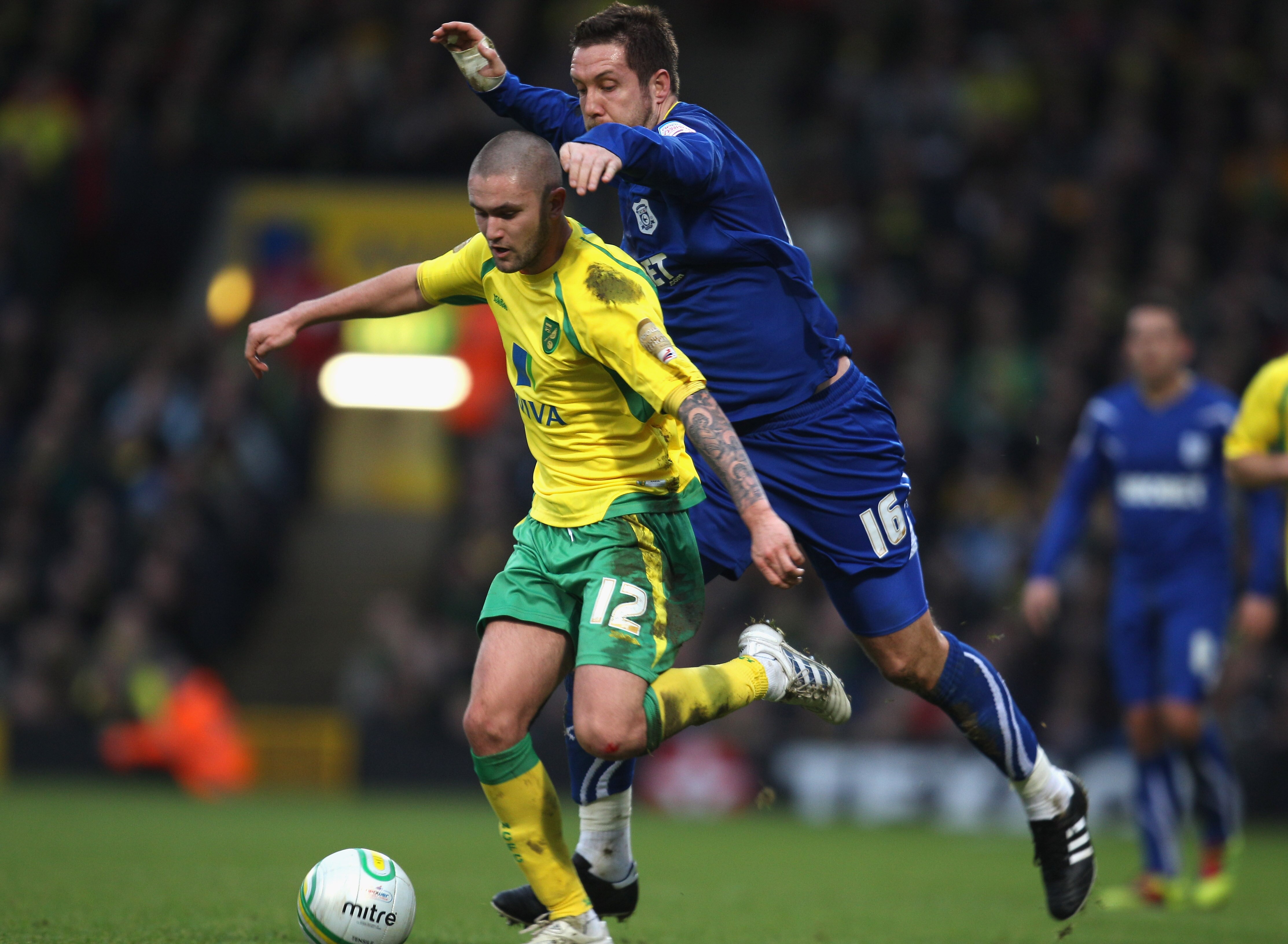 NORWICH, ENGLAND - JANUARY 15:   Henri Lansbury of Norwich City battes with Jon Parkin of Cardiff City during the npower Championship match between Norwich City and  Cardiff City at Carrow Road on January 15, 2011 in Norwich, England.  (Photo by Mark Thom