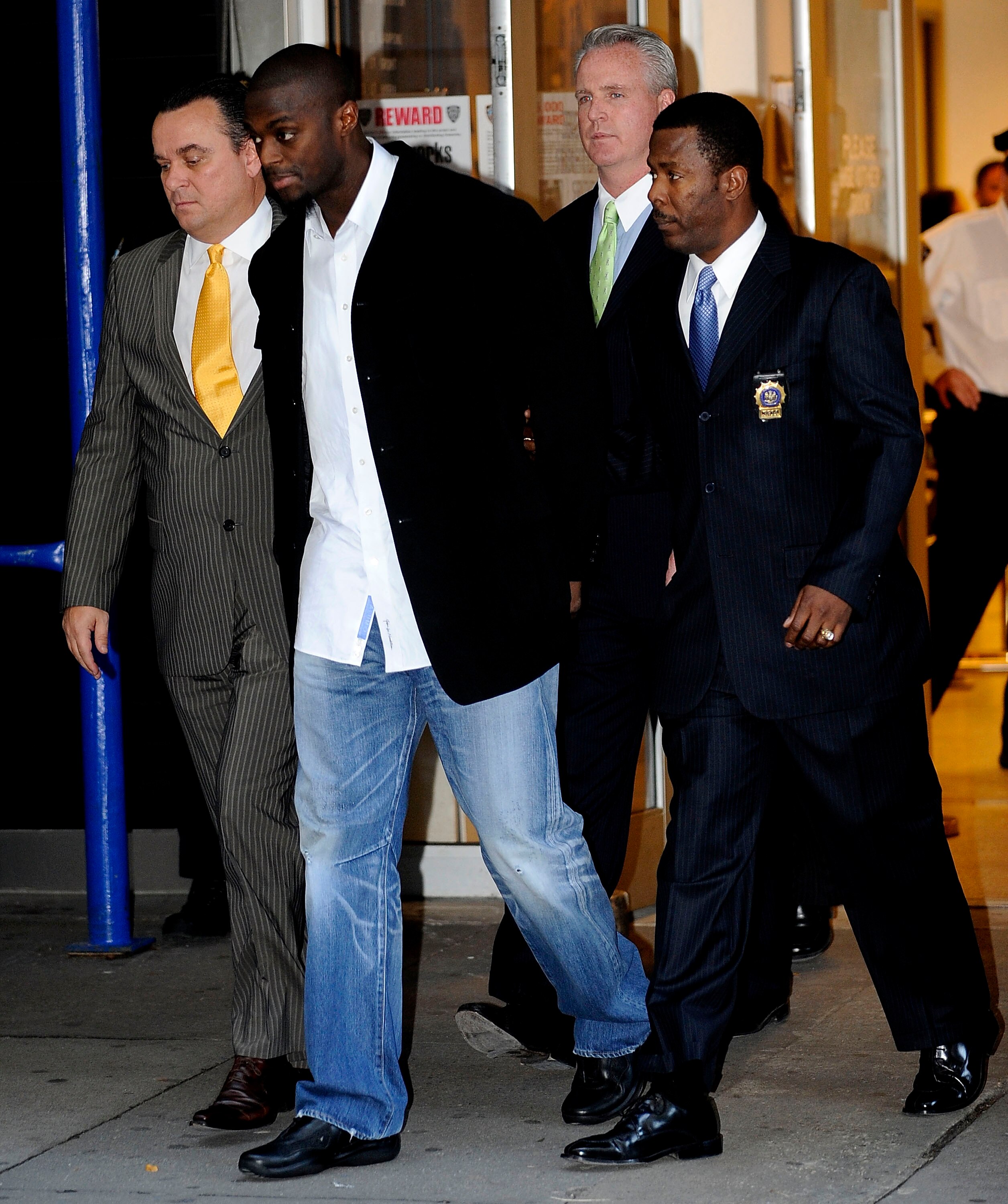 NEW YORK - DECEMBER 1:  Wide receiver Plaxico Burress (2L) of the New York Giants is led to a squad car for transport to his arraignment outside the NYPD 17th Precinct December 1, 2008 in New York City. Burress, who is expected to face a charge of crimina