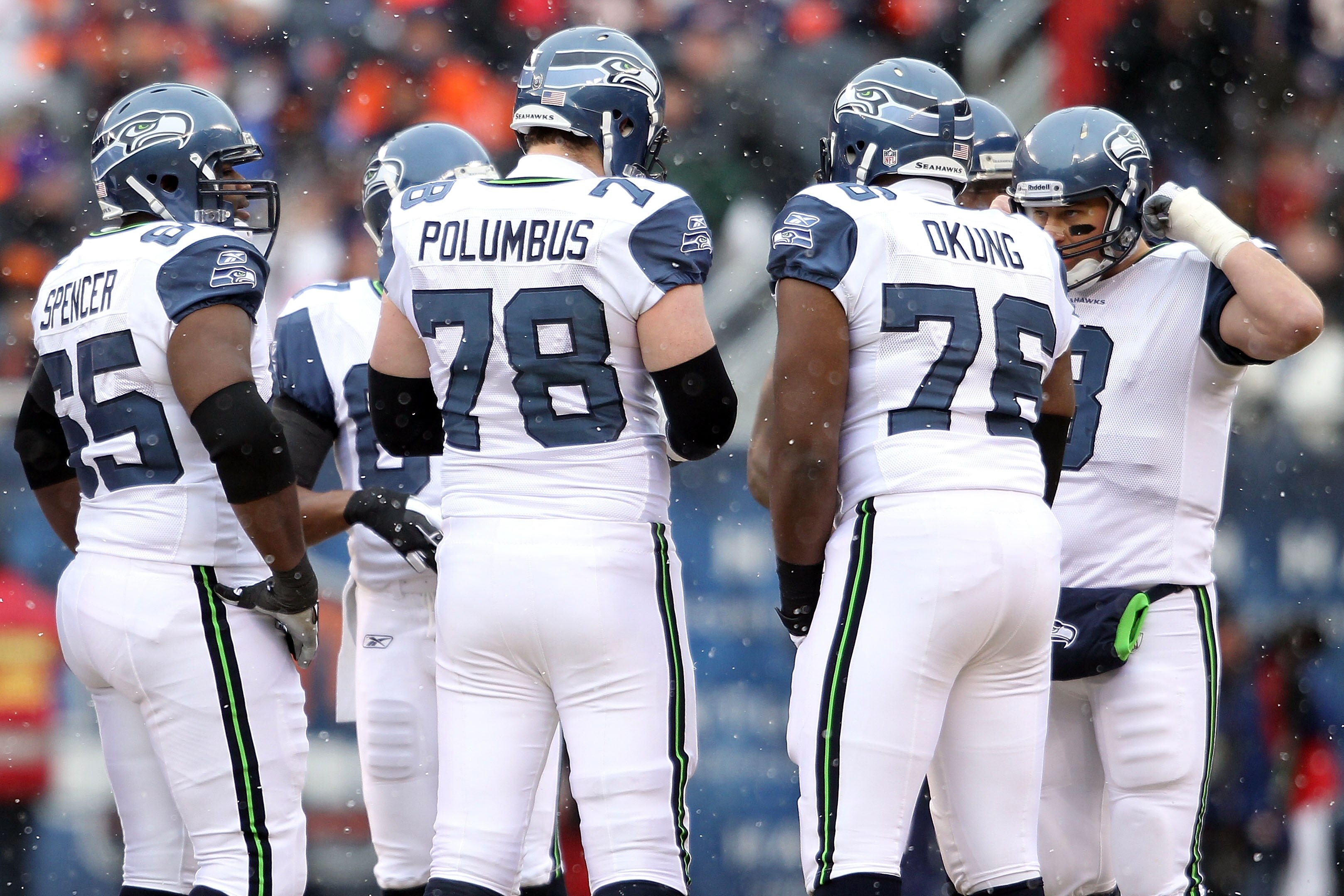 CHICAGO, IL - JANUARY 16:  (R) Quarterback Matt Hasselbeck #8 of the Seattle Seahawks huddles with Russell Okung #76, Tyler Polumbus #78 and other members of the Seahawks offensive line against the Chicago Bears in the 2011 NFC divisional playoff game at