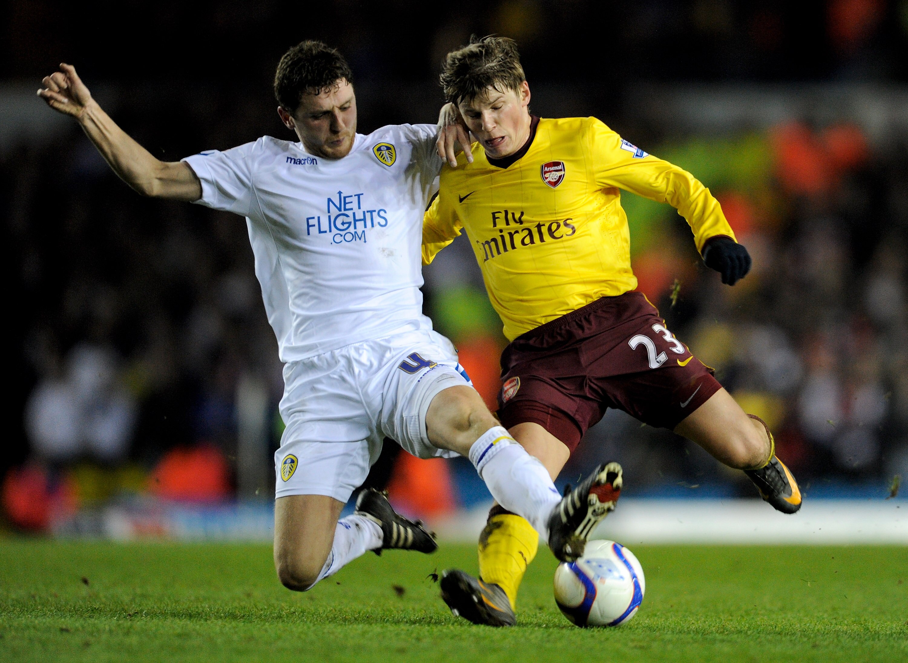 LEEDS, ENGLAND - JANUARY 19: Alex Bruce of Leeds United challenges Andrey Arshavin of Arsenal during the FA Cup sponsored by E.On Third Round Replay match between Leeds United and Arsenal at Elland Road on January 19, 2011 in Leeds, England. (Photo by Mic