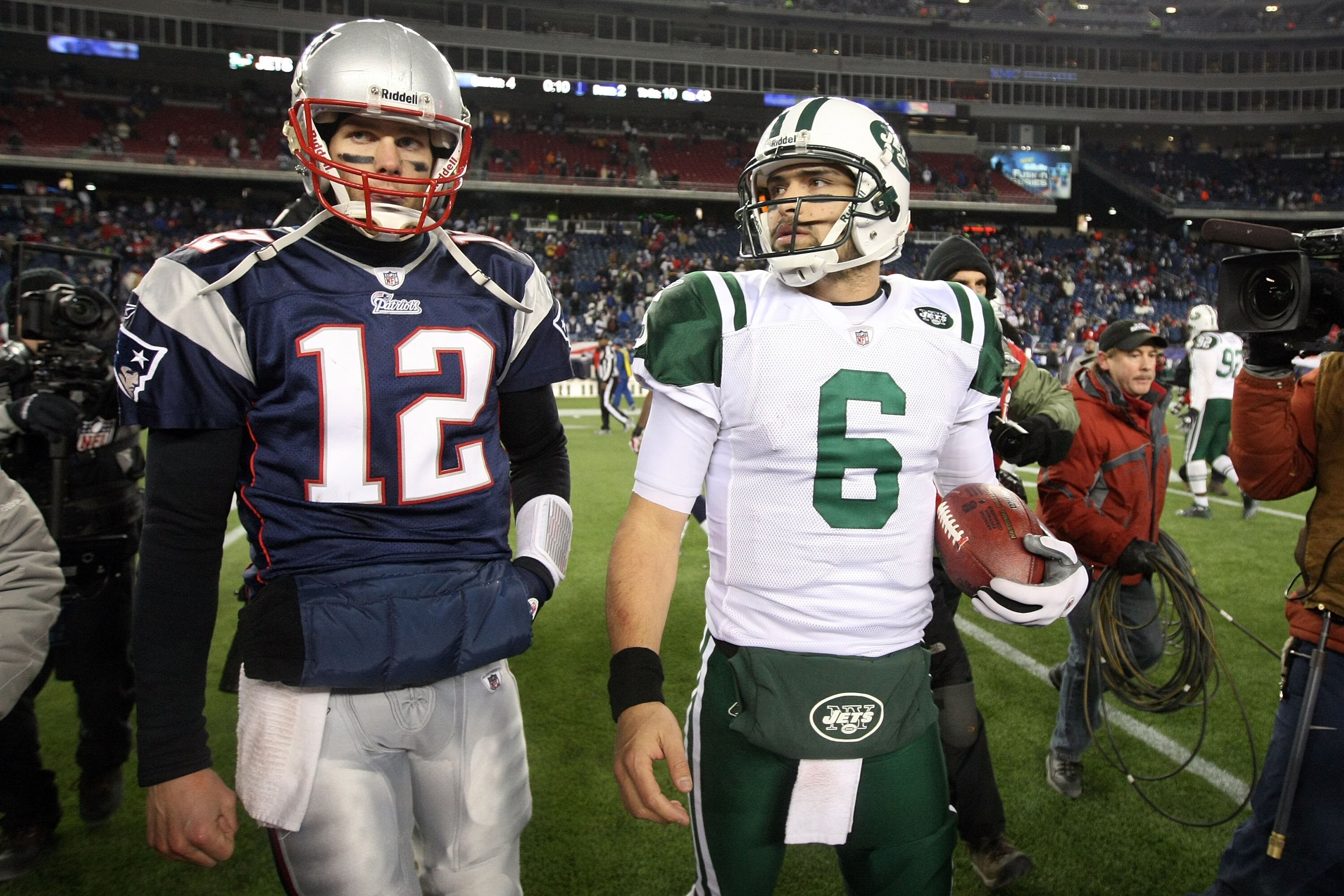FOXBORO, MA - JANUARY 16:  Tom Brady #12 of the New England Patriots and Mark Sanchez #6 of the New York Jets walk off the field after the Jets defeated the Patriots 28 to 21 their 2011 AFC divisional playoff game at Gillette Stadium on January 16, 2011 i
