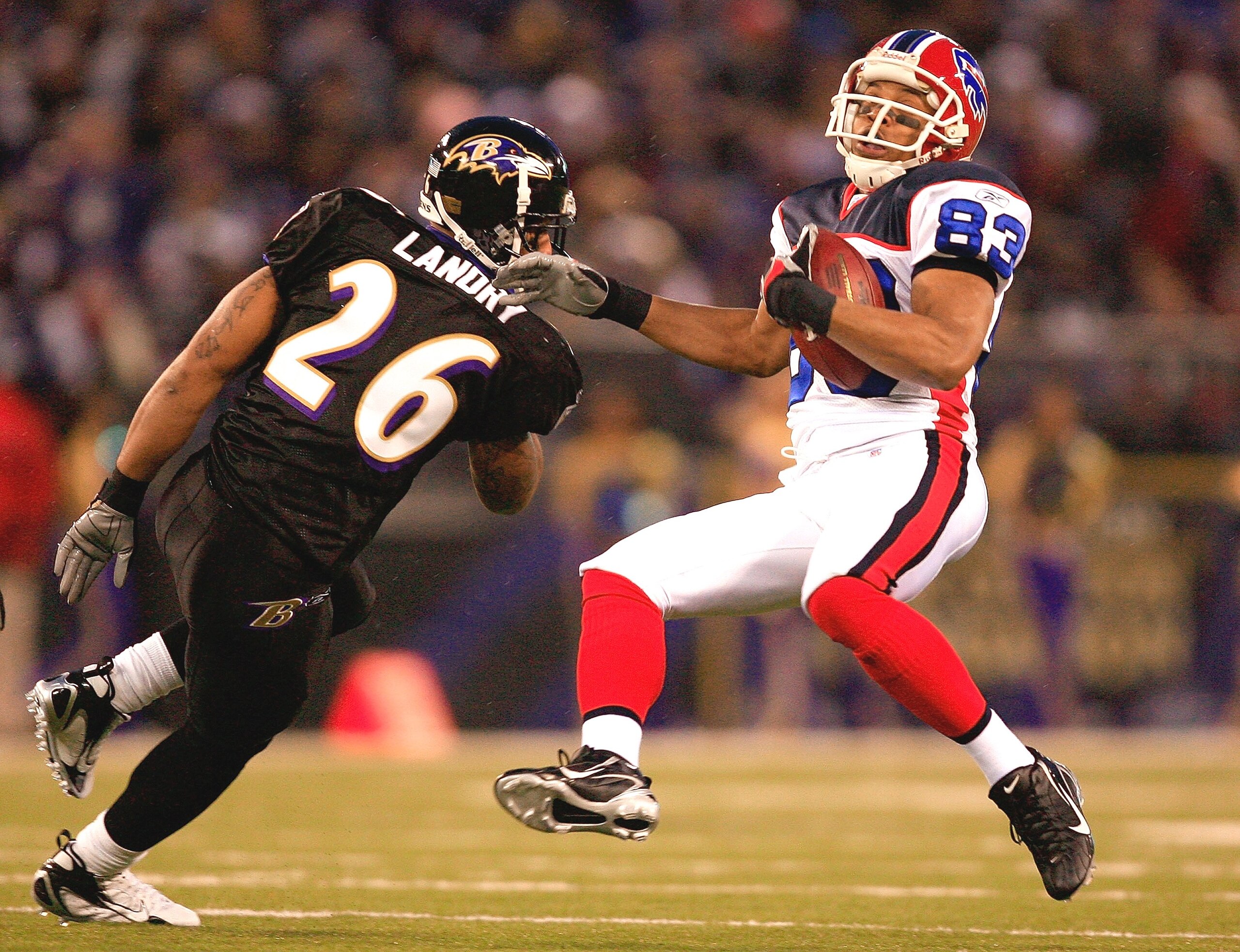 BALTIMORE - DECEMBER 31:  Receiver Lee Evans #83 of the Buffalo Bills makes a catch as Dawan Landry #26 of the Baltimore Ravens defends during the game on December 31, 2006 at M&T Bank Stadium in Baltimore, Maryland.  (Photo by Jamie Squire/Getty Images)