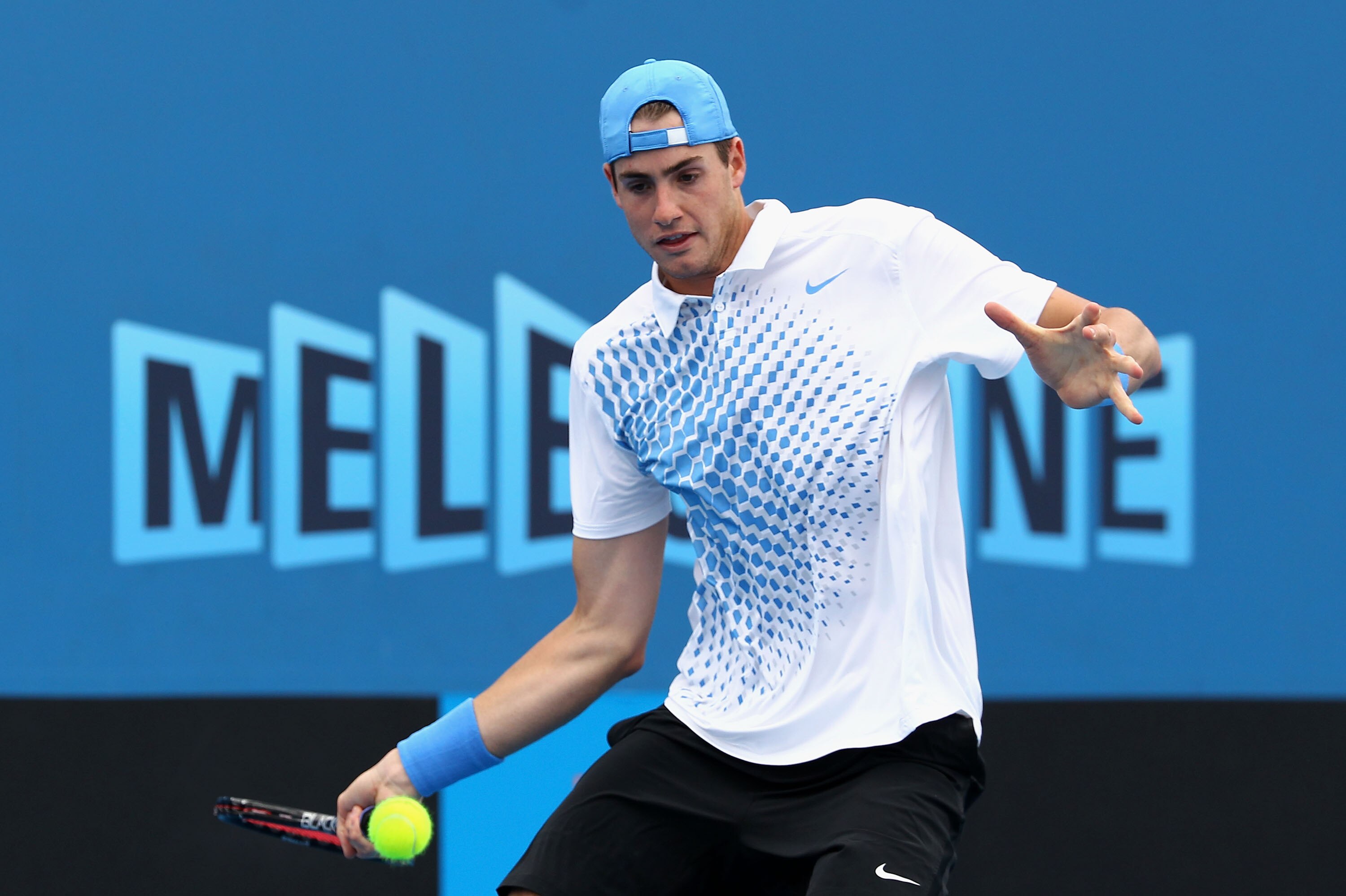 MELBOURNE, AUSTRALIA - JANUARY 18:  John Isner of the United States of America plays a forehand during his first round match against Florent Serra of France during day two of the 2011 Australian Open at Melbourne Park on January 18, 2011 in Melbourne, Aus