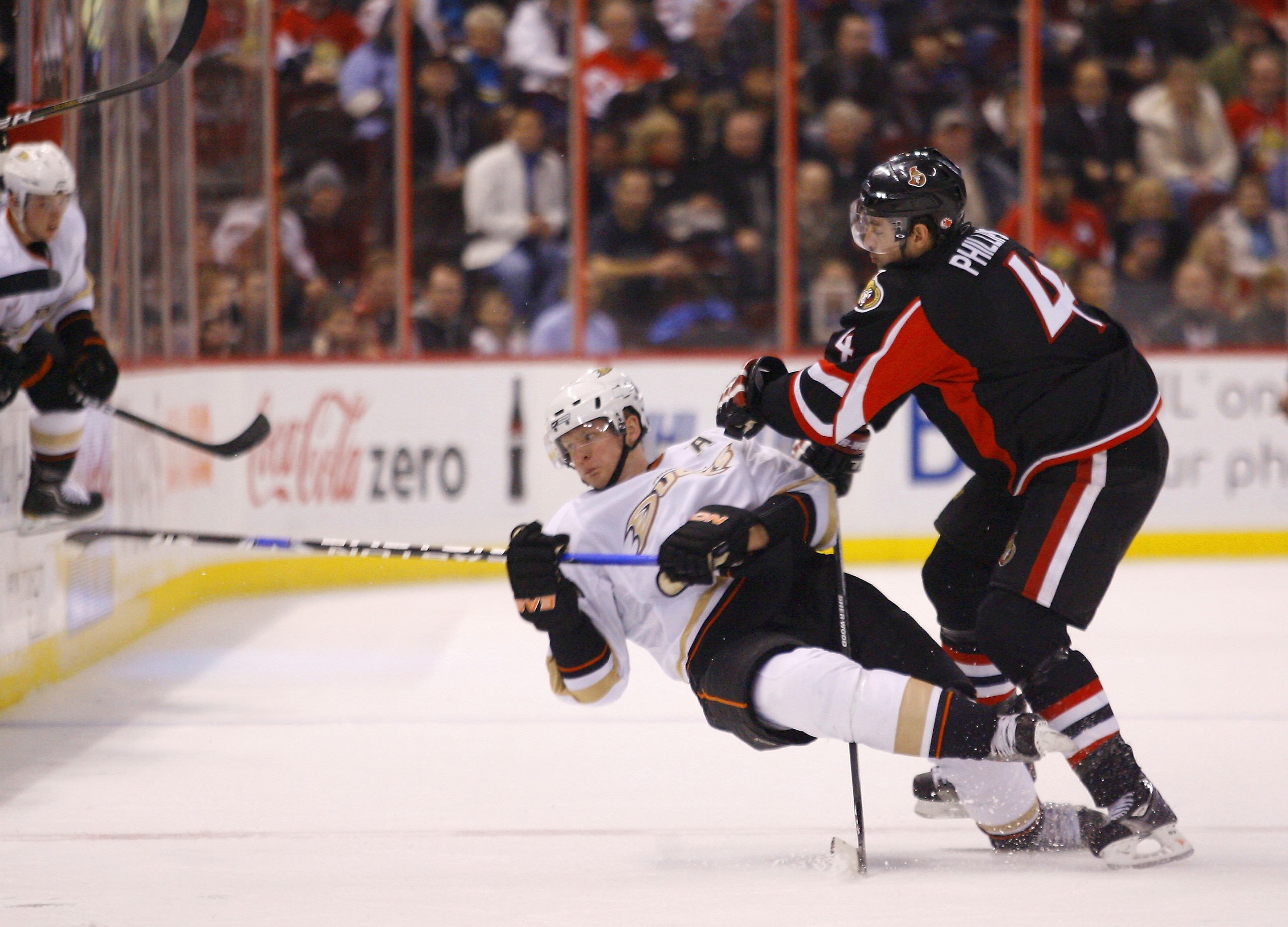 OTTAWA, ON - JANUARY 18:  Chris Phillips #4 of the Ottawa Senators throws a bodycheck on Corey Perry #10 of the Anaheim Ducks at centre ice in a game at Scotiabank Place on January 18, 2011 in Ottawa, Canada.  (Photo by Phillip MacCallum/Getty Images)