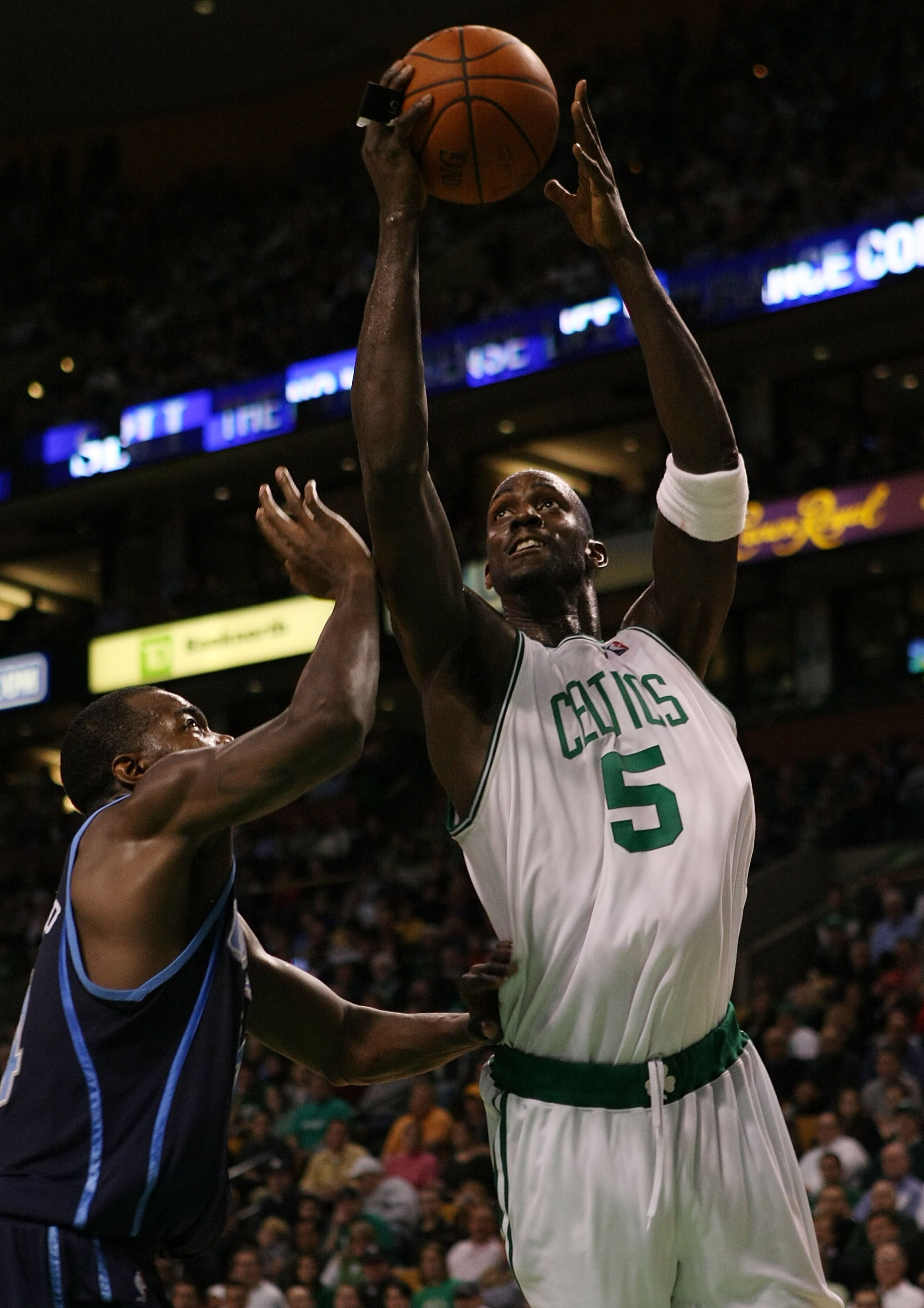 BOSTON - DECEMBER 15:  Kevin Garnett #5 of the Boston Celtics heads to the basket as Paul Millsap #24 of the Utah Jazz defends on December 15, 2008 at TD Banknorth Garden in Boston, Massachusetts. The Celtics defeated the Jazz 100-91. NOTE TO USER: User e
