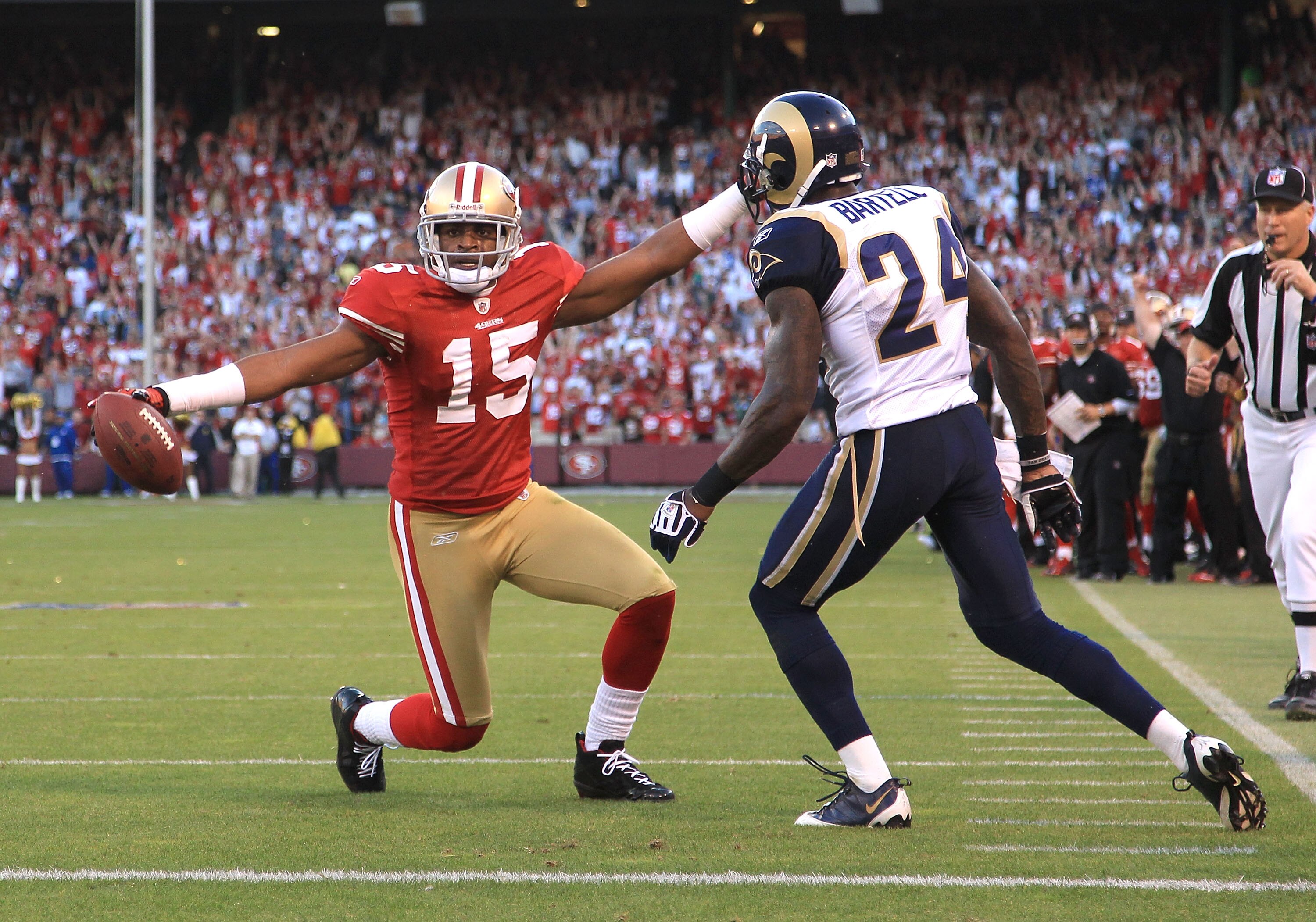 SAN FRANCISCO - NOVEMBER 14:  Michael Crabtree #15 of the San Francisco 49ers celebrates after scoring a touchdown while defended by Ron Bartell #24 of the St. Louis Rams at Candlestick Park on November 14, 2010 in San Francisco, California.  (Photo by Ez