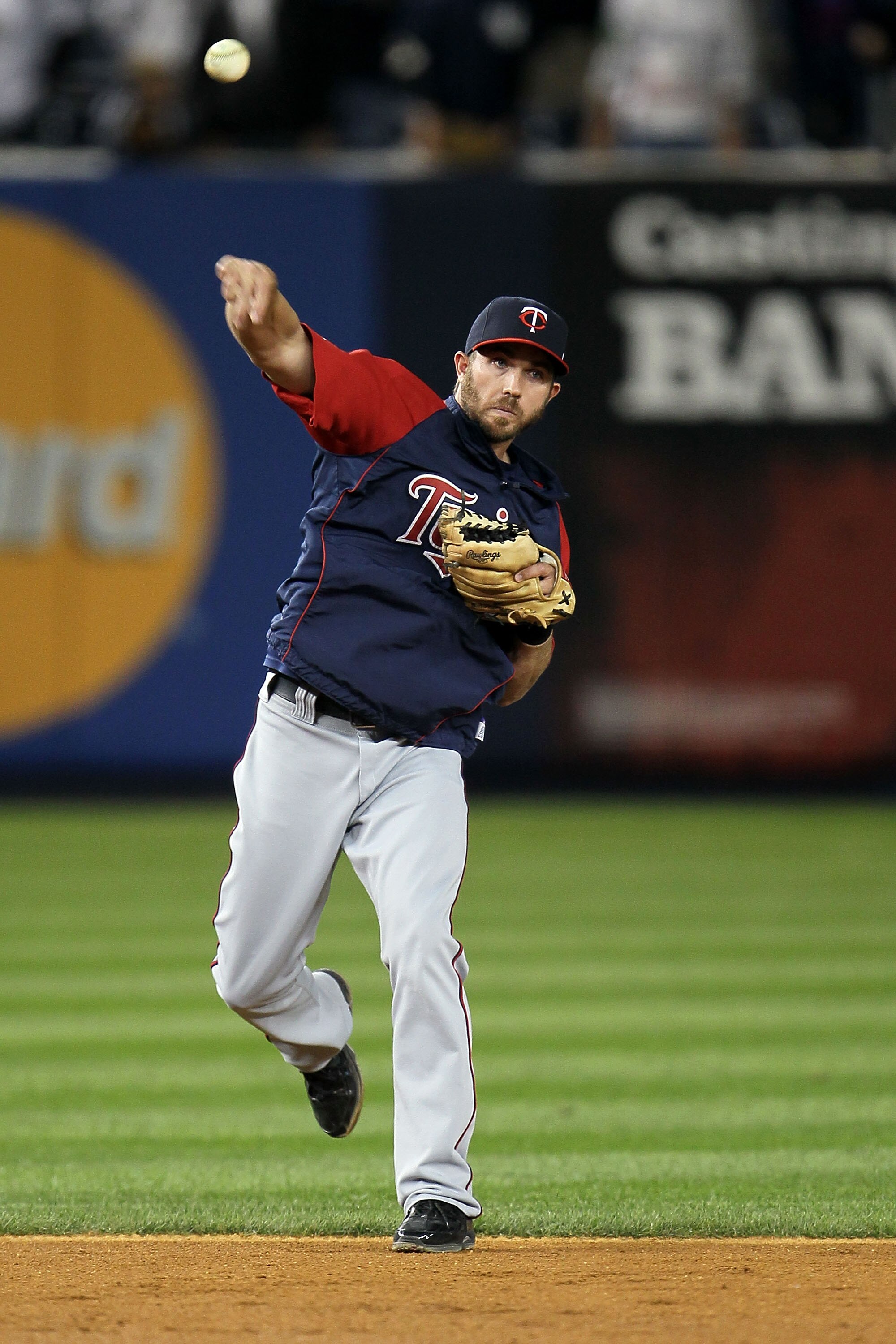 NEW YORK - OCTOBER 09:  J.J. Hardy #27 of the Minnesota Twins warms up against the New York Yankees  during Game Three of the ALDS part of the 2010 MLB Playoffs at Yankee Stadium on October 9, 2010 in the Bronx borough of New York City.  (Photo by Chris M