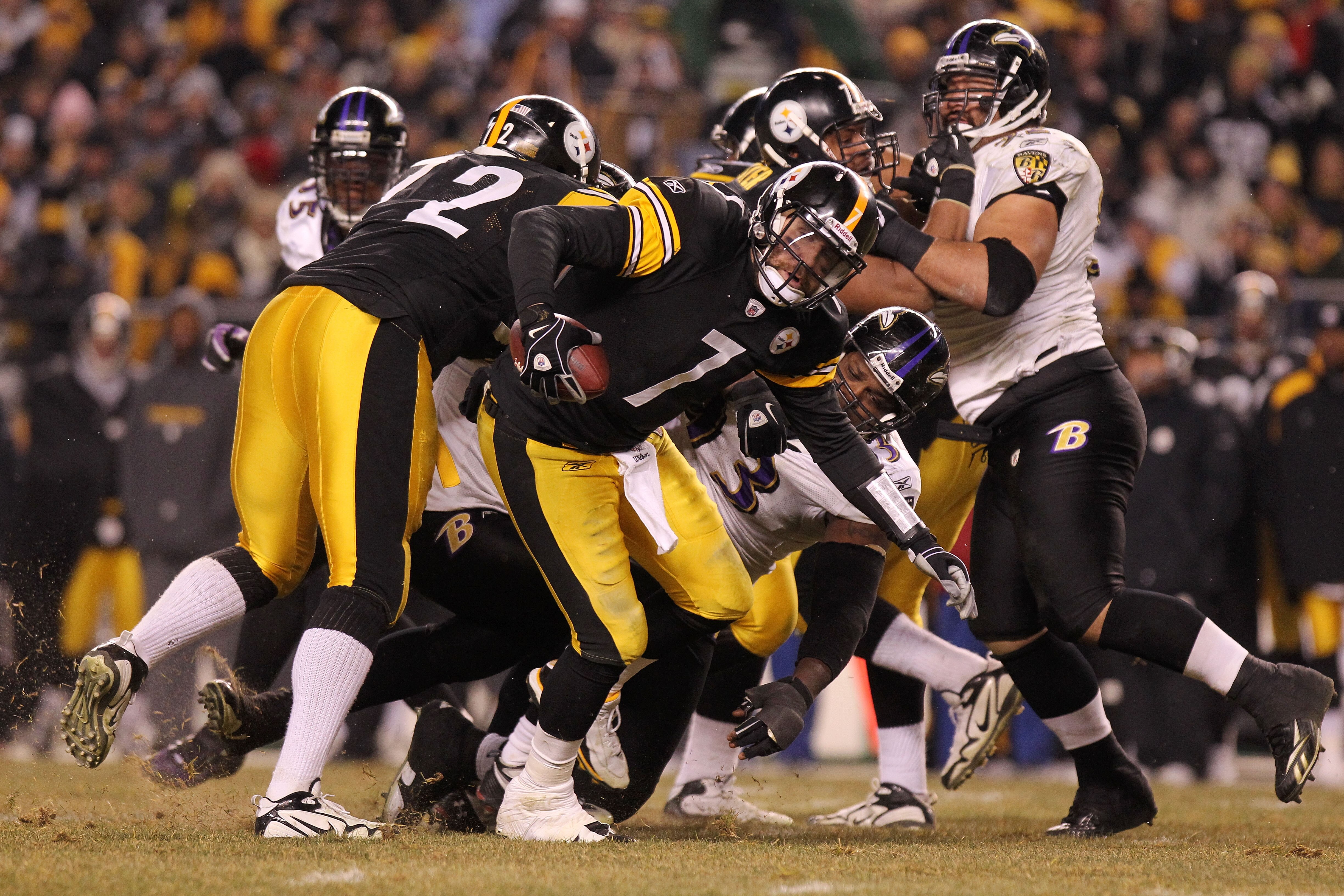 PITTSBURGH, PA - JANUARY 15:  Quarterback Ben Roethlisberger #7 of the Pittsburgh Steelers breaks a tackle by defensive end Cory Redding #93 of the Baltimore Ravens in the AFC Divisional Playoff Game at Heinz Field on January 15, 2011 in Pittsburgh, Penns
