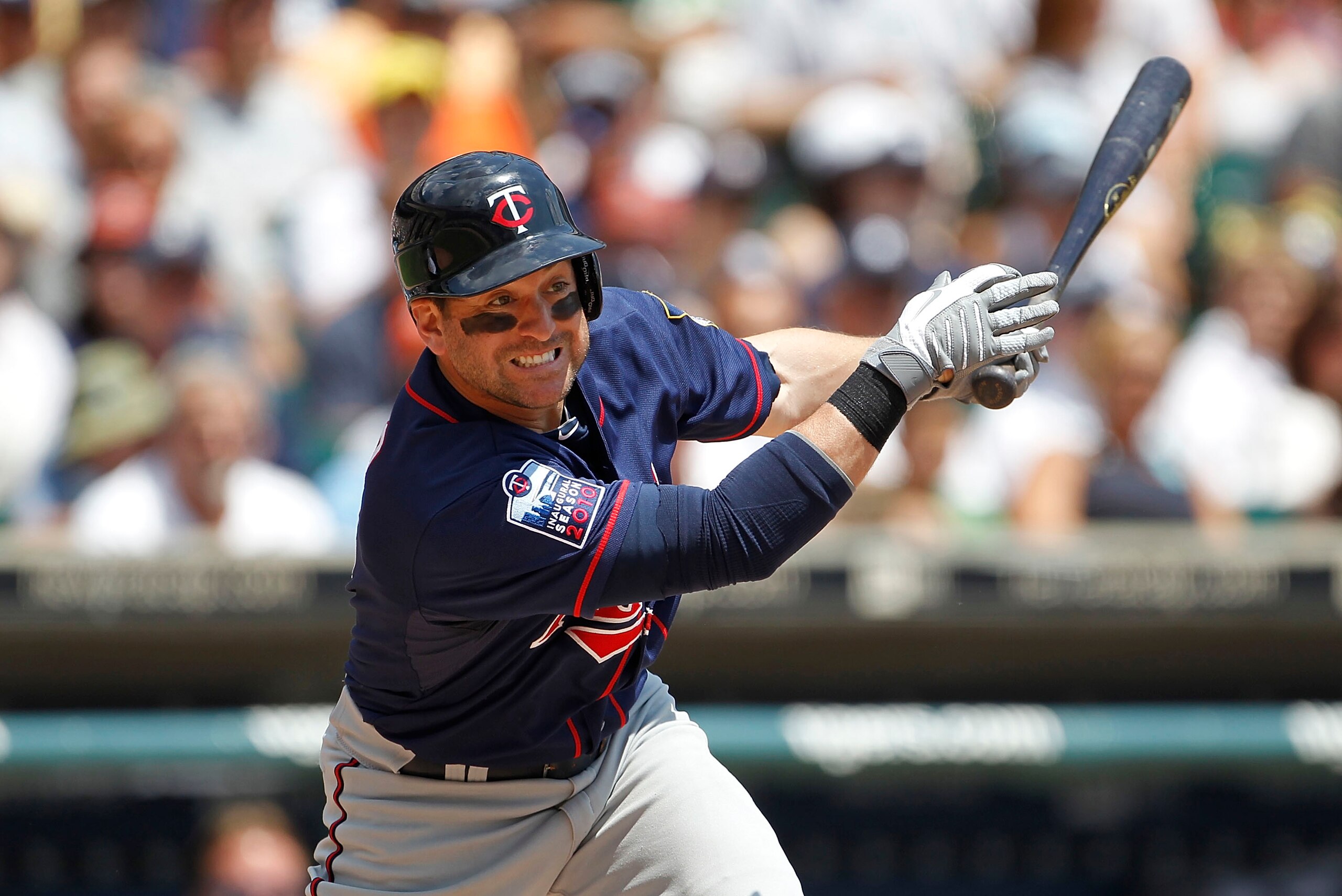 DETROIT - JULY 11:  Nick Punto #8 of the Minnesota Twins singles in the fourth inning during the game against the Detroit Tigers on July 11, 2010 at Comerica Park in Detroit, Michigan. The Twins defeated the Tigers 6-3.  (Photo by Leon Halip/Getty Images)