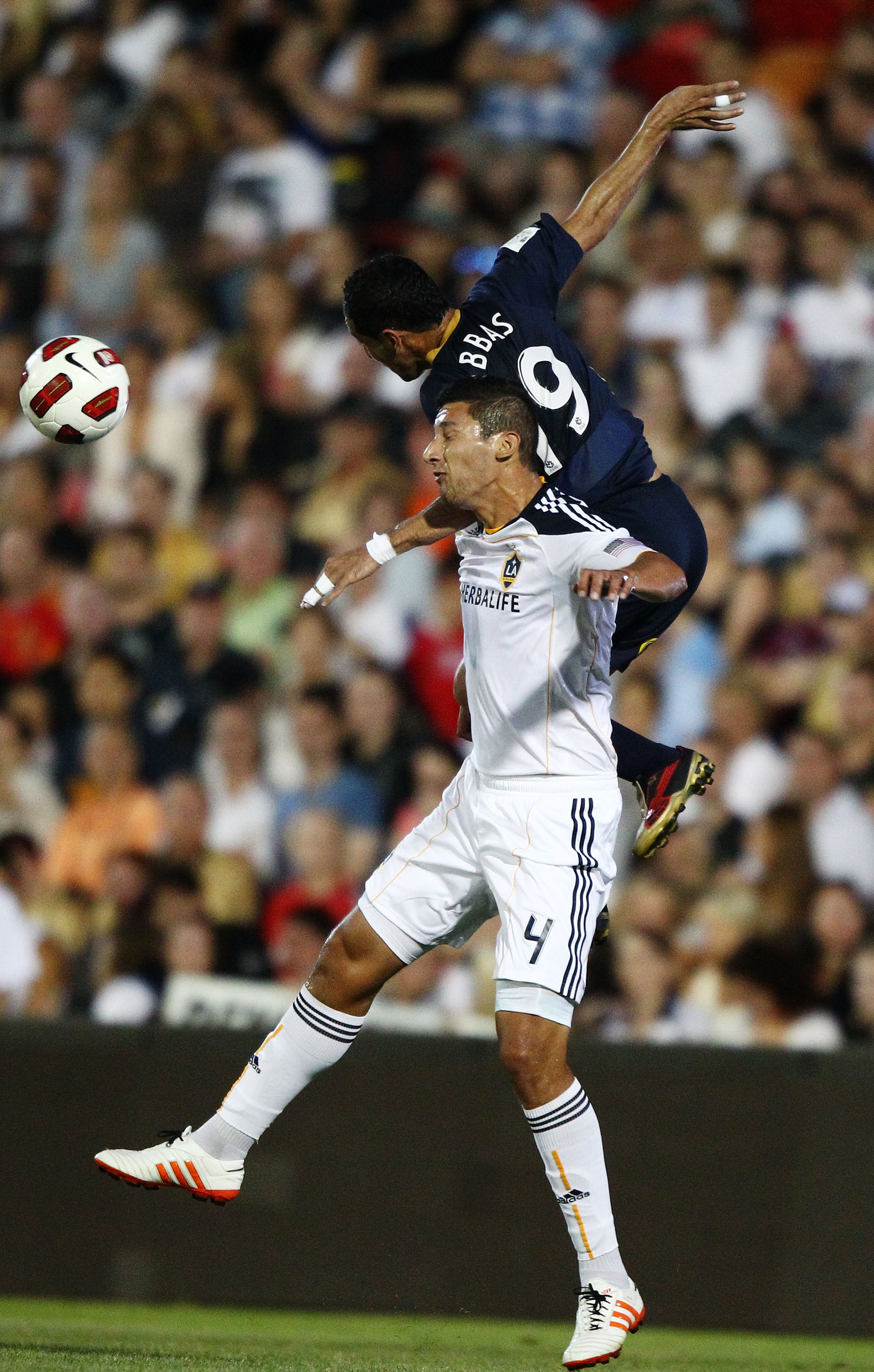 NEWCASTLE, AUSTRALIA - NOVEMBER 27: Ali Abbas of the Jets competes with Omar Gonzalez of the Galaxy during the friendly match between the Newcastle Jets and the LA Galaxy at EnergyAustralia Stadium on November 27, 2010 in Newcastle, Australia.  (Photo by