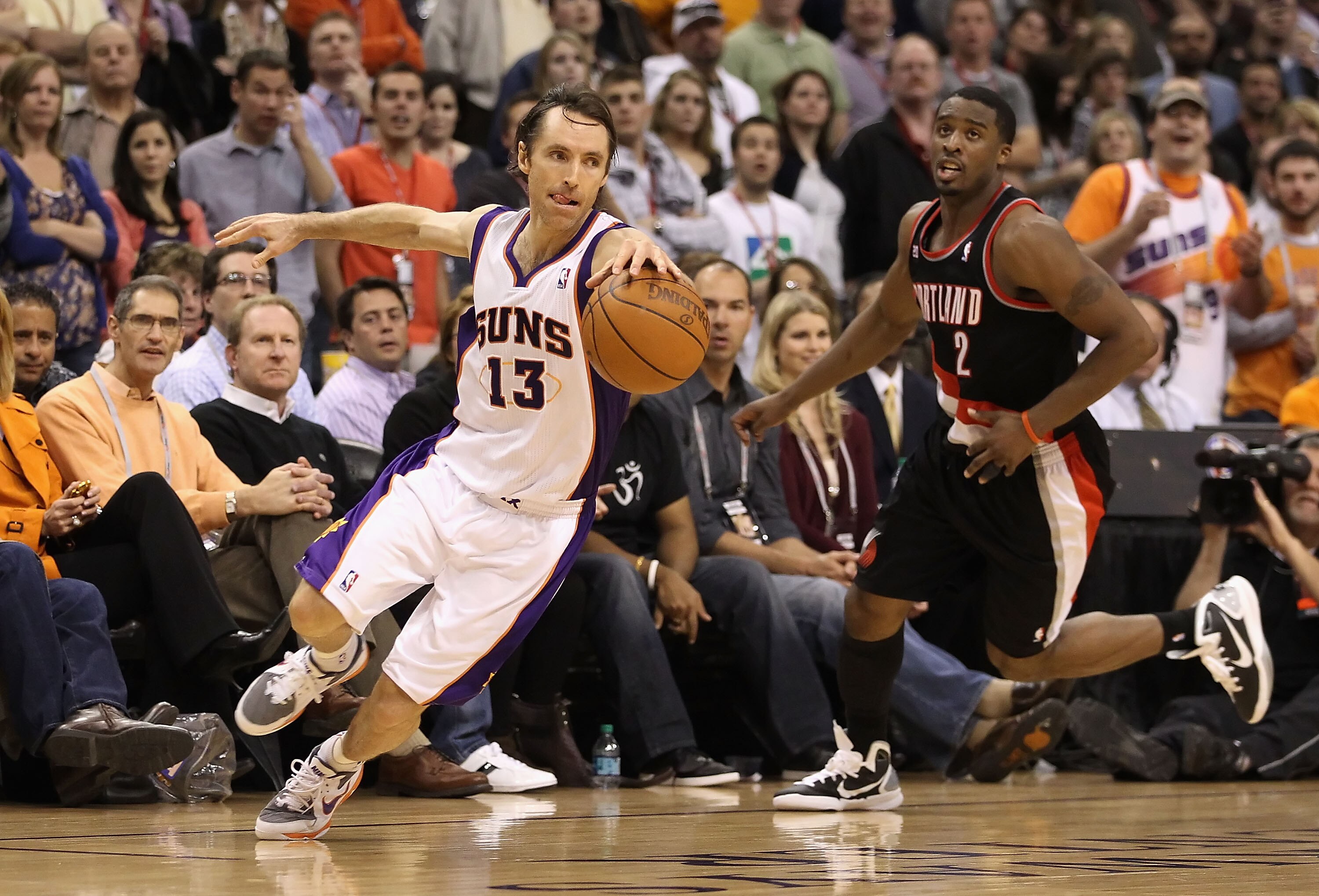 PHOENIX, AZ - JANUARY 14:  Steve Nash #13 of the Phoenix Suns handles the ball past Wesley Matthews #2 of the Portland Trail Blazers during the NBA game at US Airways Center on January 14, 2011 in Phoenix, Arizona.  The Suns defeated the Trail Blazers 115
