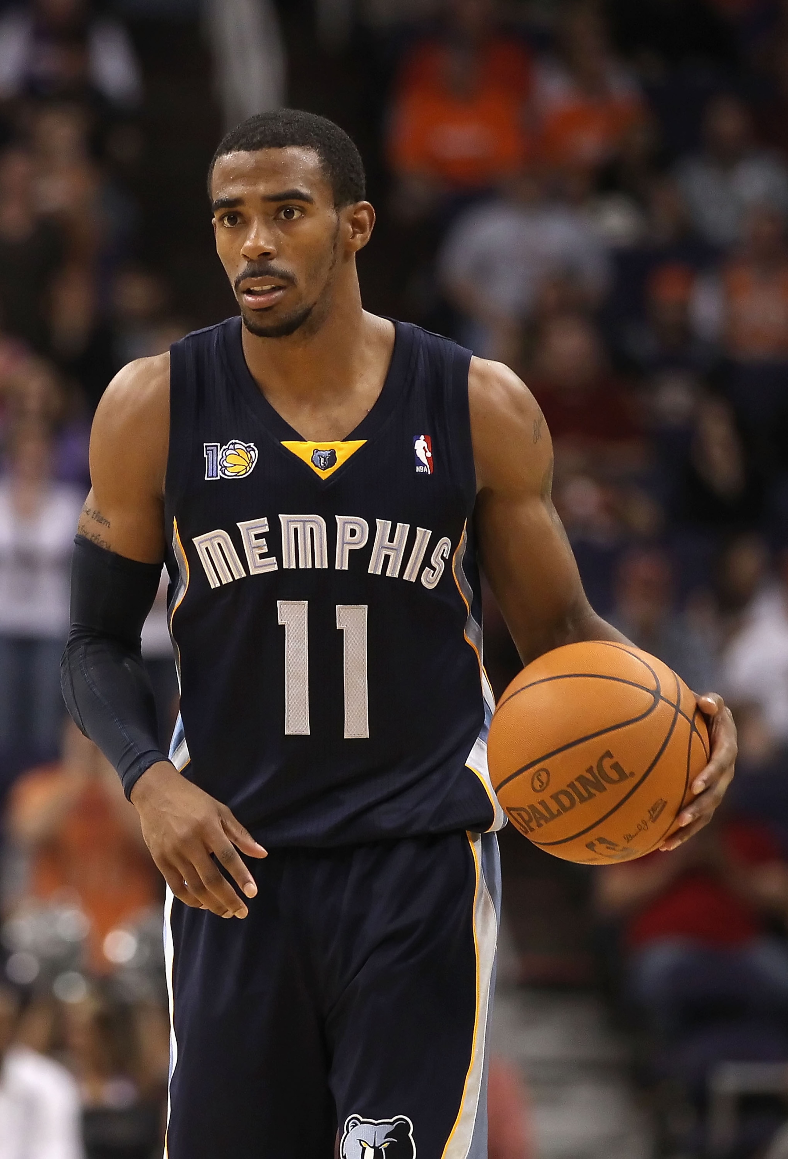 PHOENIX - NOVEMBER 05:  Mike Conley #11 of the Memphis Grizzlies handles the ball during the NBA game against the Phoenix Suns at US Airways Center on November 5, 2010 in Phoenix, Arizona. NOTE TO USER: User expressly acknowledges and agrees that, by down