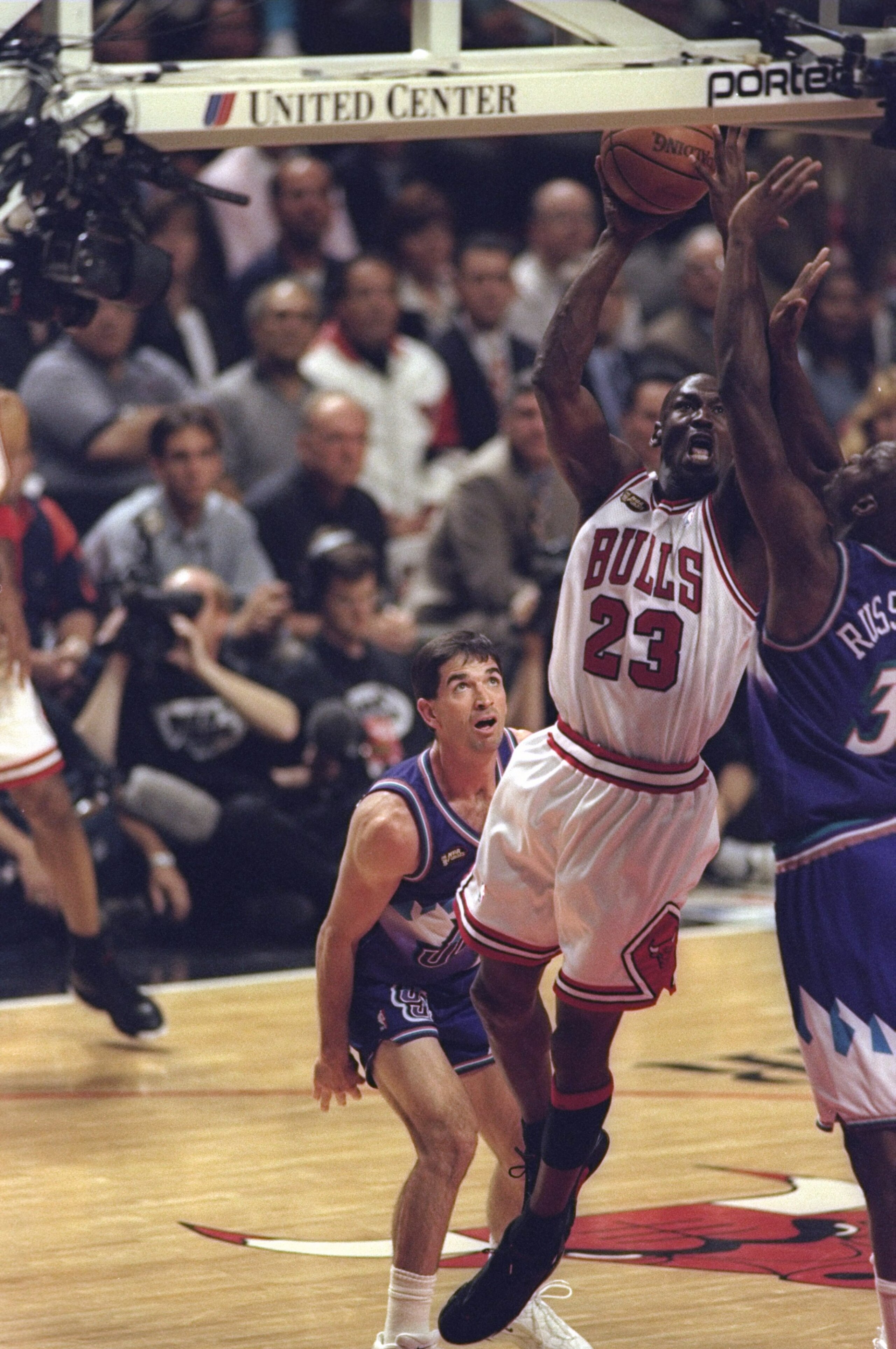10 Jun 1998:  Michael Jordan #23 of the Chicago Bulls in action against John Stockton #12 and Bryon Russell #3 of the Utah Jazz during the NBA Finals Game 4 at the United Center in Chicago, Illinois.  The Bulls defeated the Jazz 86-82. Mandatory Credit: M