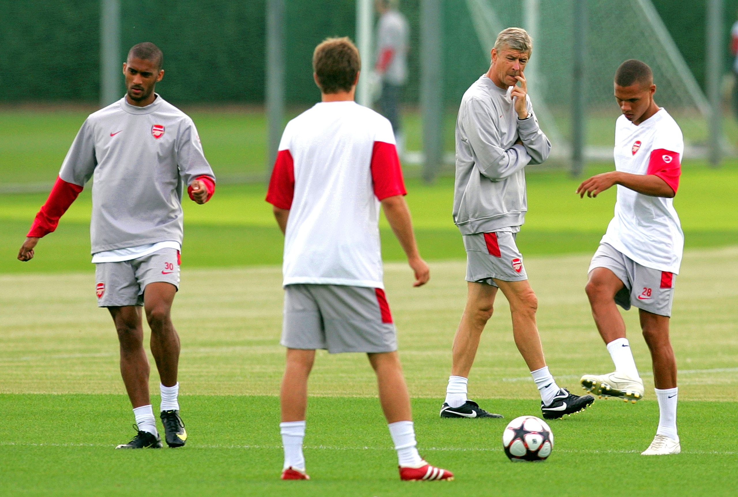 ST ALBANS, ENGLAND - AUGUST 17: Manager Arsene Wenger looks on as the players warm up during an Arsenal training session prior to Tuesday's Champions League fixture against Celtic at London Colney training ground on August 17, 2009 in St Albans, England.