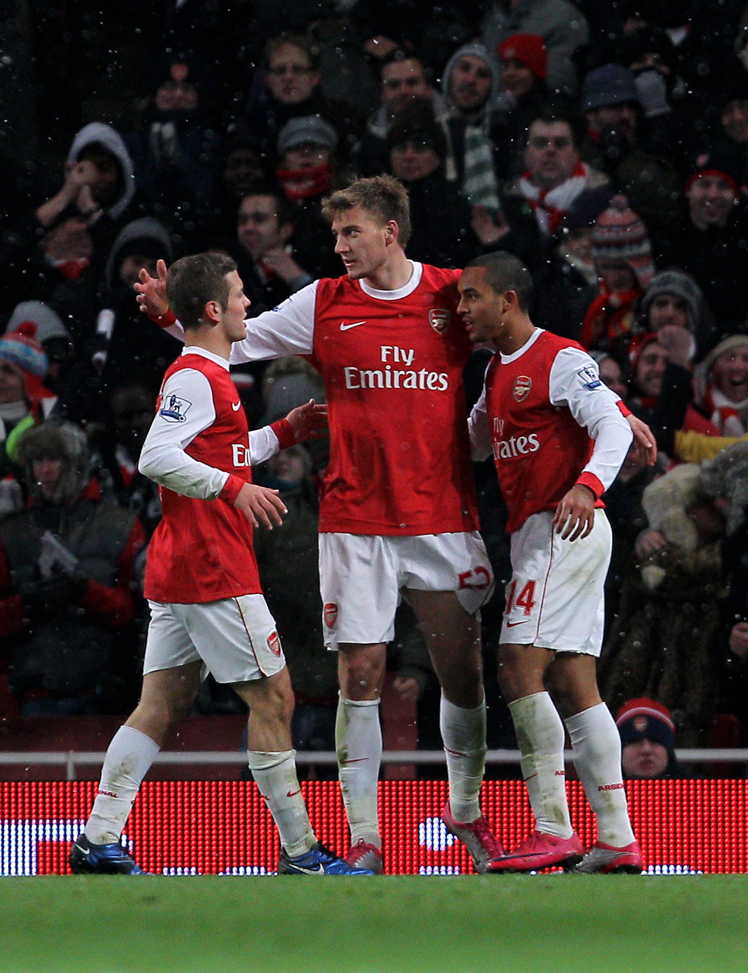 LONDON, ENGLAND - NOVEMBER 30:  Nicklas Bendtner (C) of Arsenal celebrates scoring a goal with teammates Jack Wilshere (L) and Theo Walcott (R) during the Carling Cup quarter final match between Arsenal and Wigan Athletic at the Emirates Stadium on Novemb